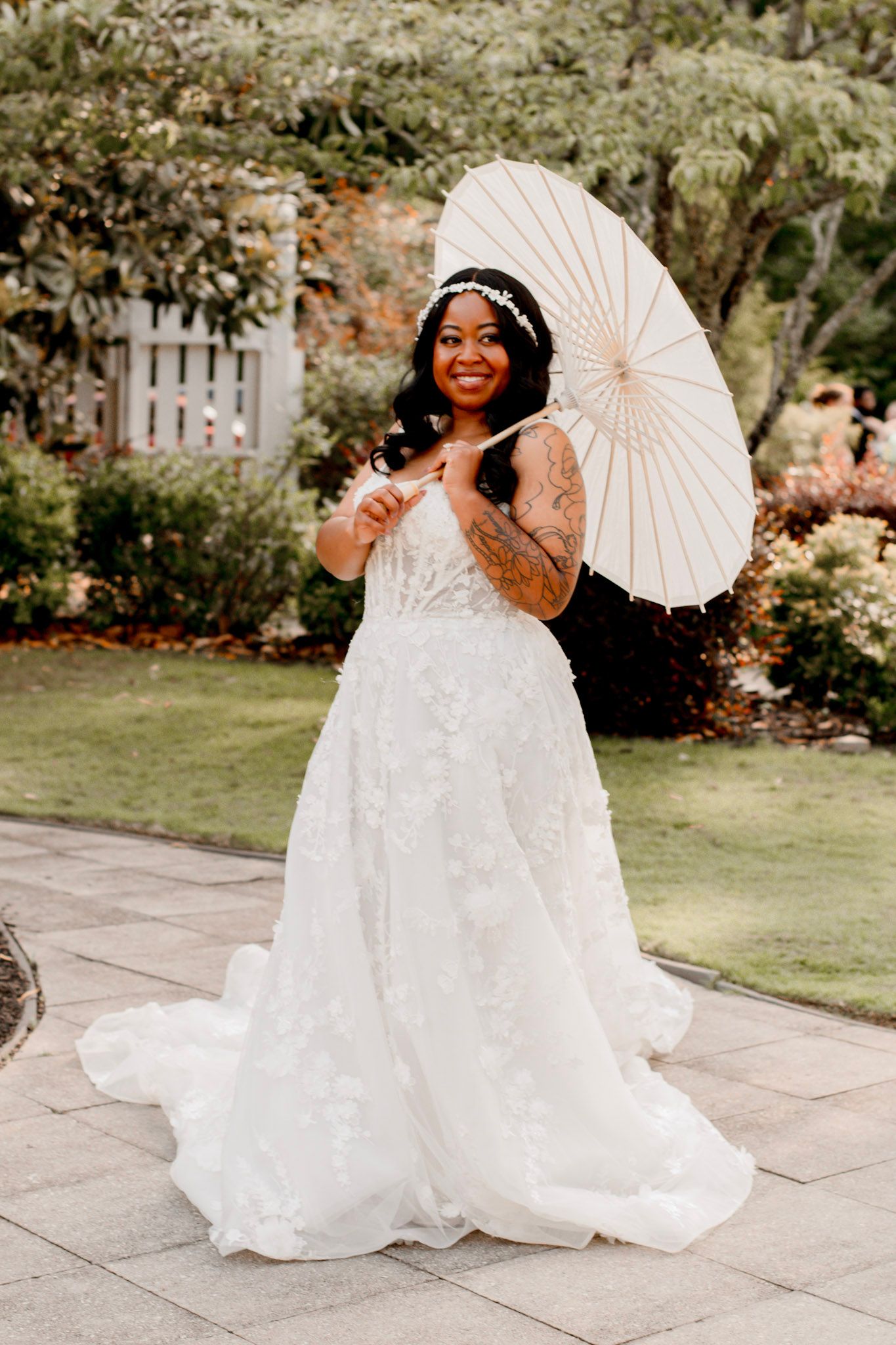 A bride portrait in a white lace wedding gown poses in a garden setting at Wildflower 301 Venue in Greensboro, Georgia