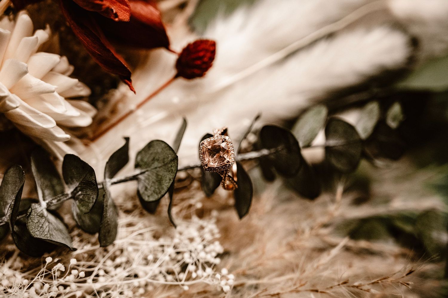 Close-up macro shot of an engagement ring resting on flowers at The Little Cottage in Smyrna, Georgia