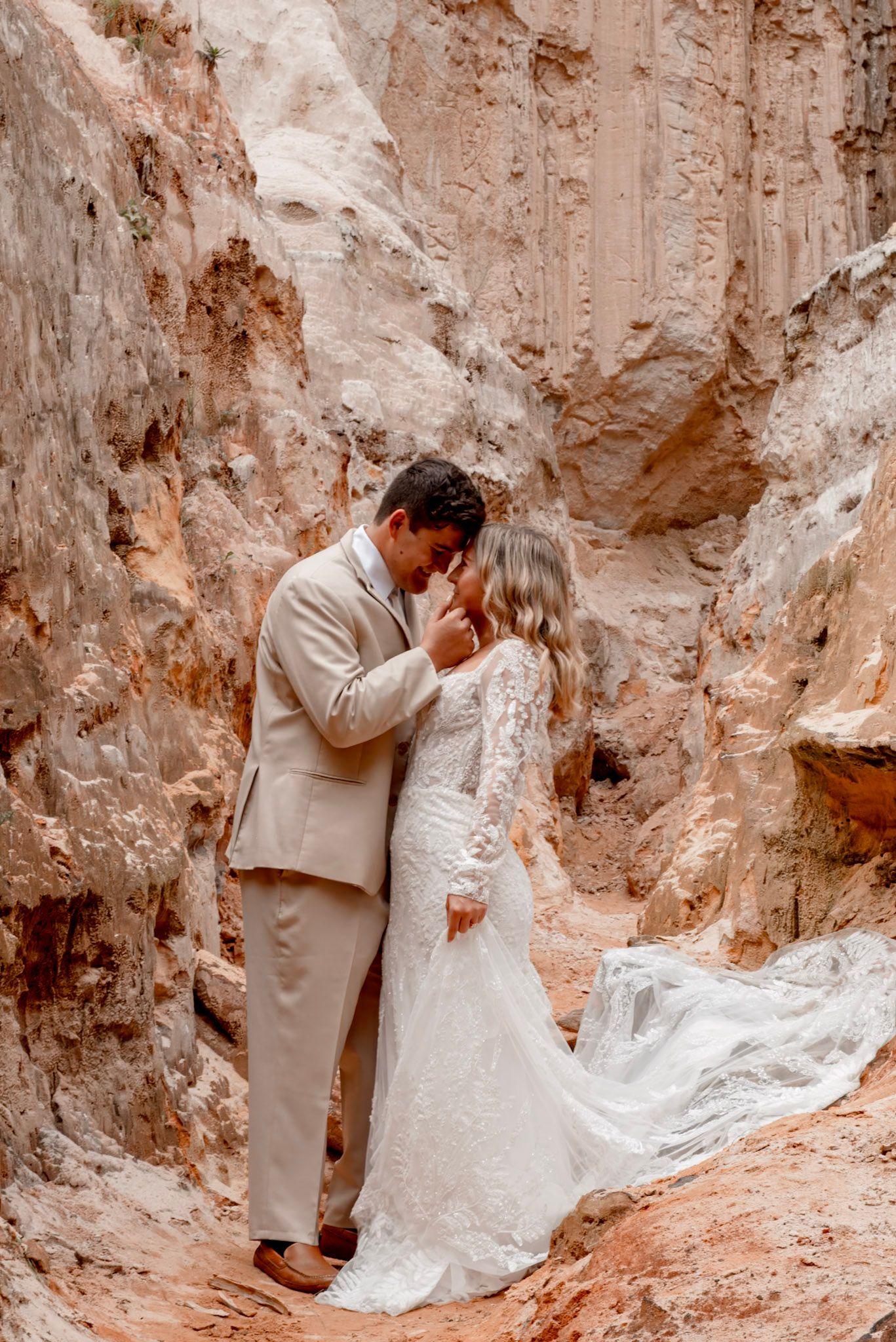 A romantic wedding photo with soft beige rock formations and natural lighting at Providence Canyon in Lumpkin, Georgia