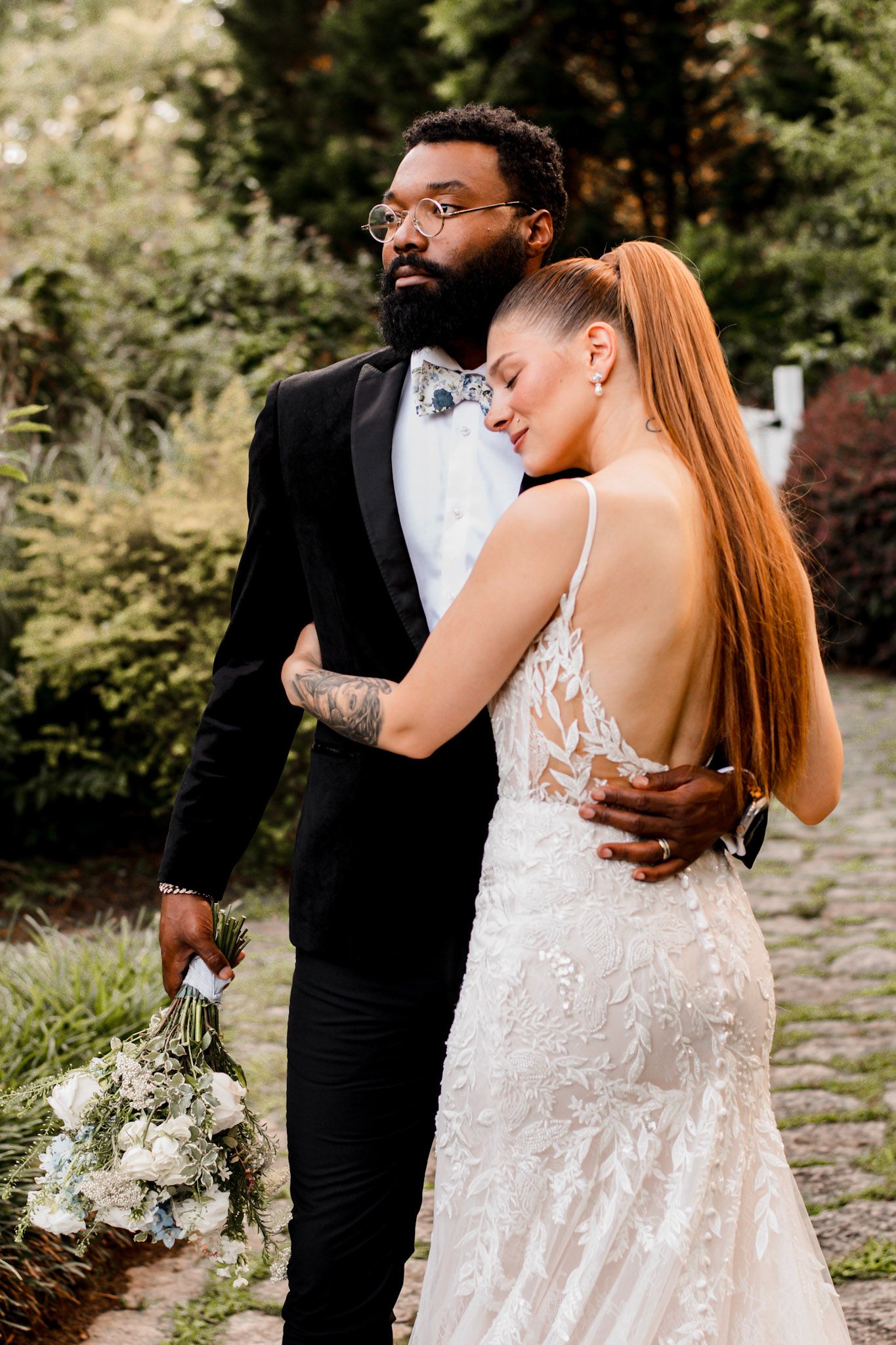 A joyful wedding couple shares intimate moments in a garden setting at Wildflower 301 Venue in Greensboro, Georgia.