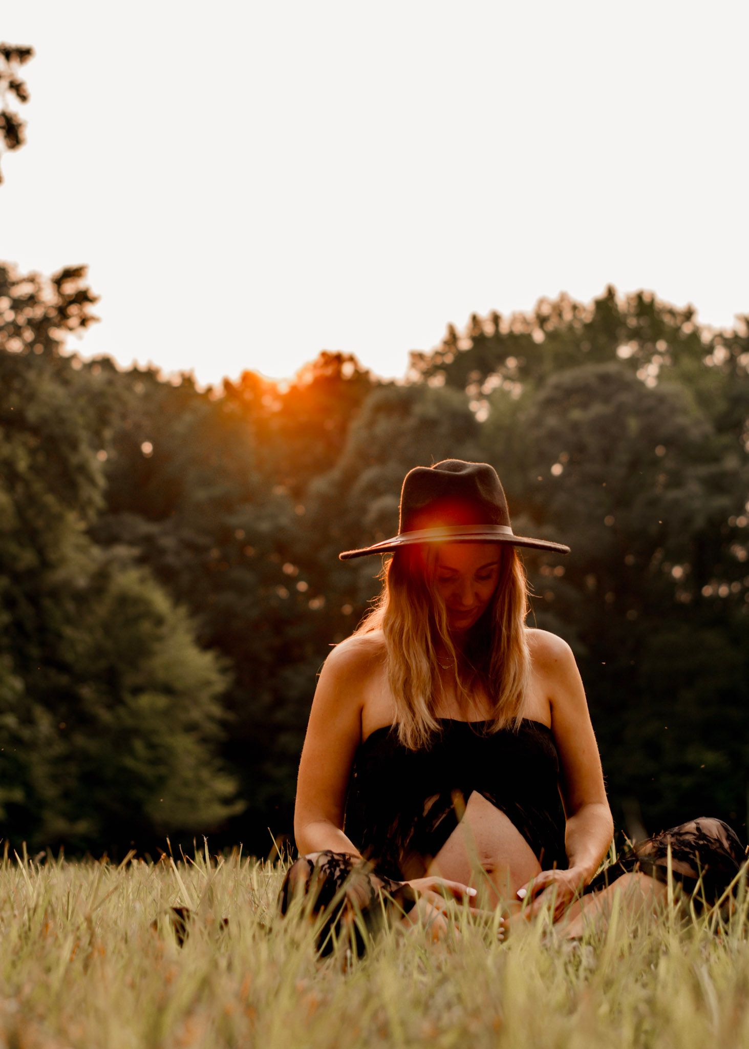 A mother in a sunlit meadow at golden hour, creating a dreamy summer atmosphere at Kennesaw Mountain in Kennesaw, Georgia