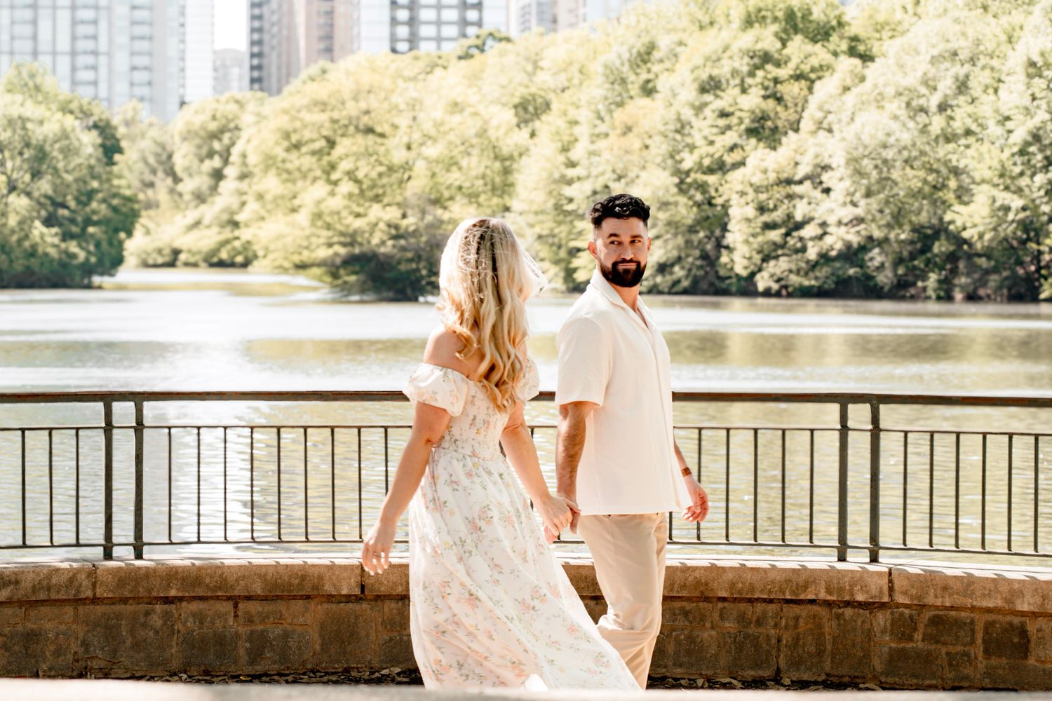 A romantic couple at an engagement session at Piedmont park in warm sunlit nature setting in Atlanta, Georgia