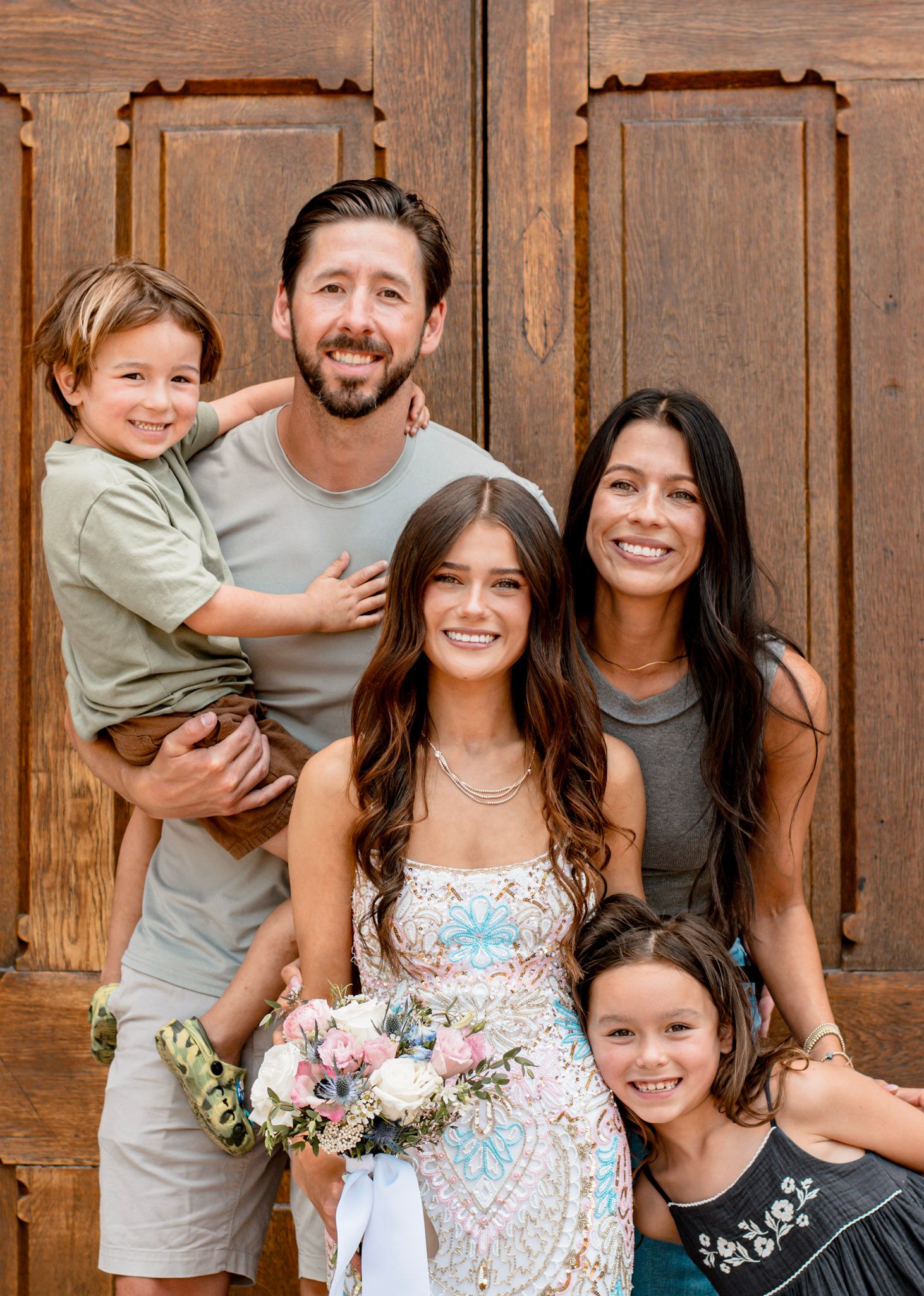 Family portrait against rustic wooden door background showing candid moments for a senior prom session at Oxford College in Oxford, Georgia.