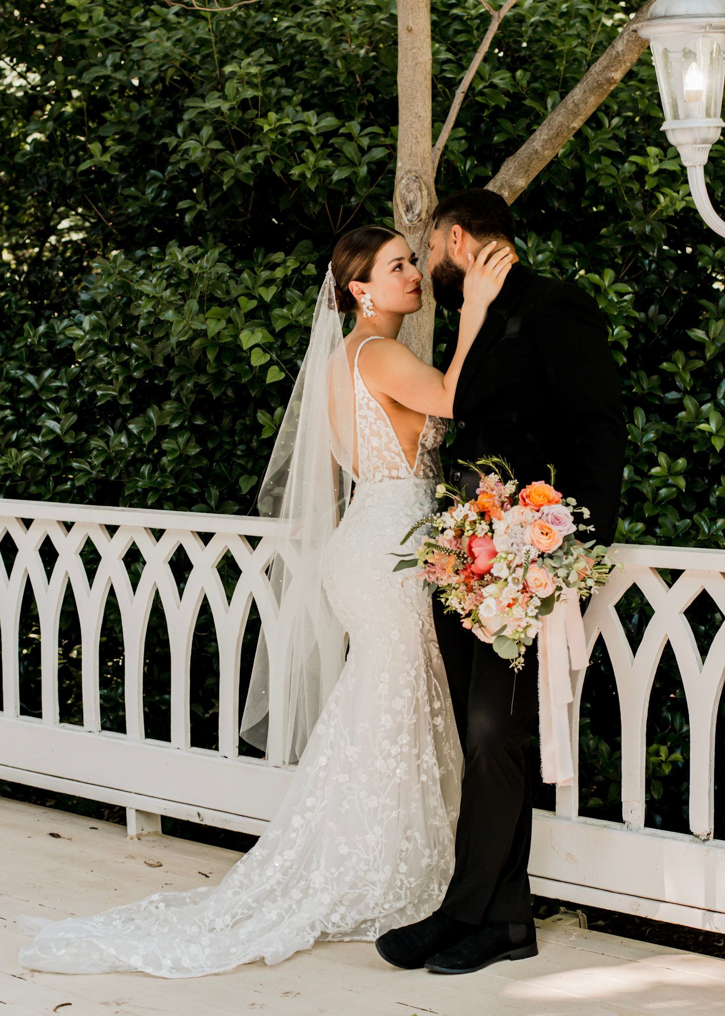 A romantic wedding, a bride and groom share an intimate moment on a white gazebo at Wildflower 301 Venue in Greensboro, Georgia
