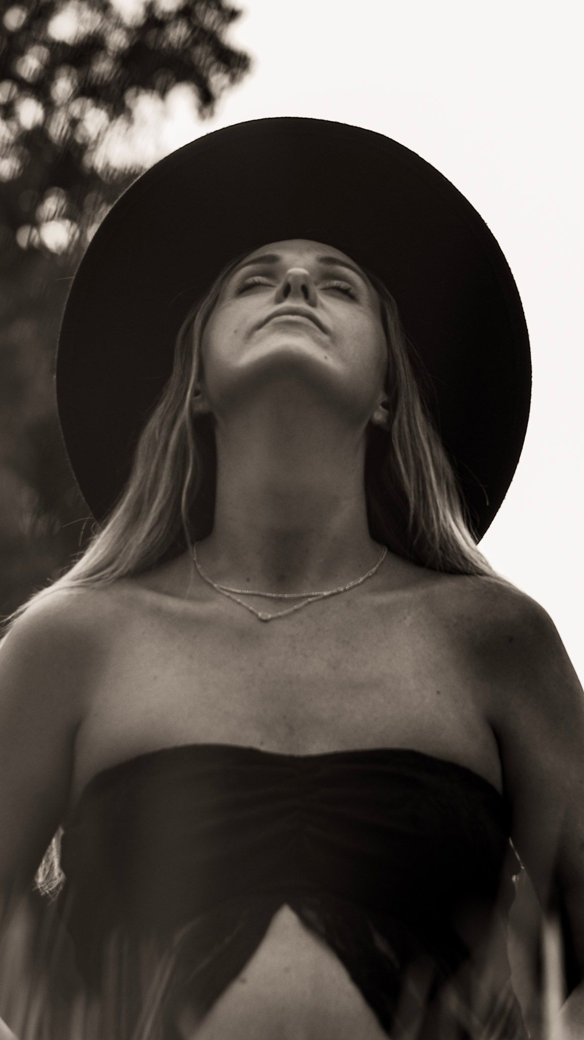 Artistic black and white maternity portrait showing dramatic angles of a mother in moody lighting at Kennesaw Mountain in Kennesaw, Georgia