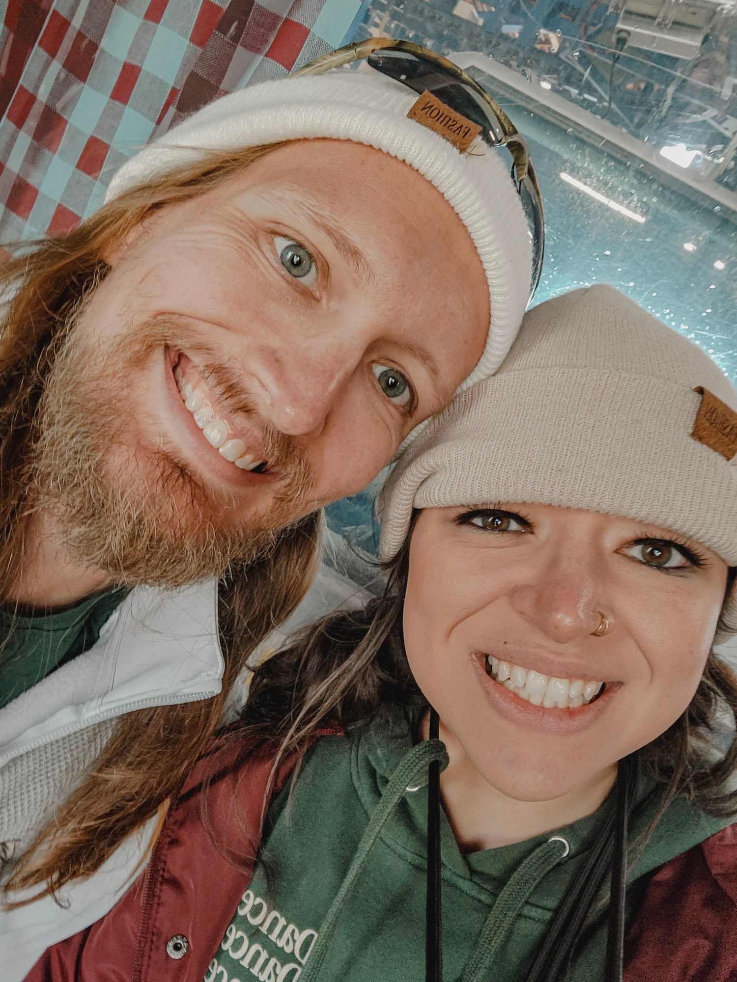 Emily Hall and husband smiling at the camera.