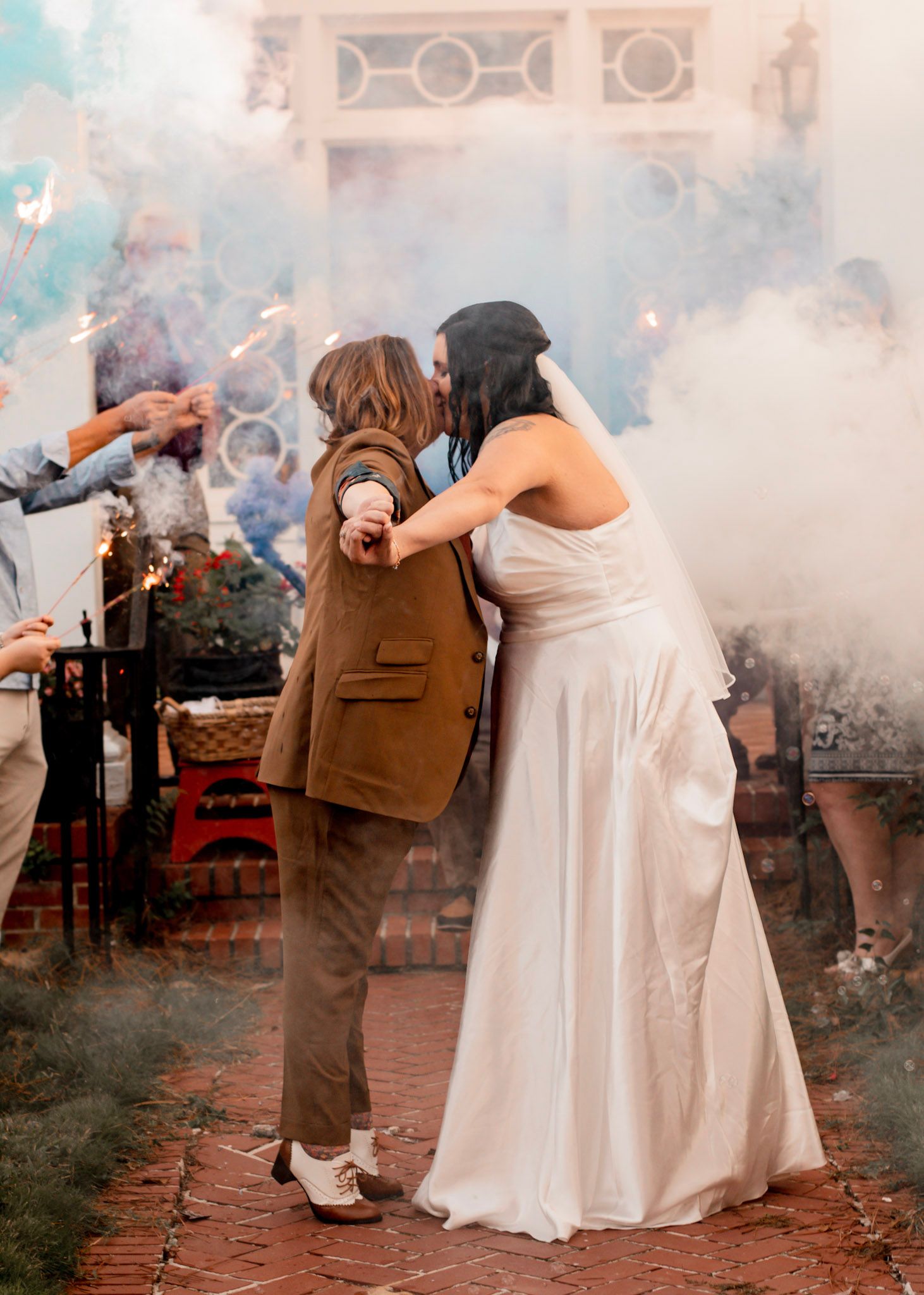 A couple poses with smoke bombs creating a dreamy atmospheric effect in their outdoor wedding photoshoot in Albany, Georgia.