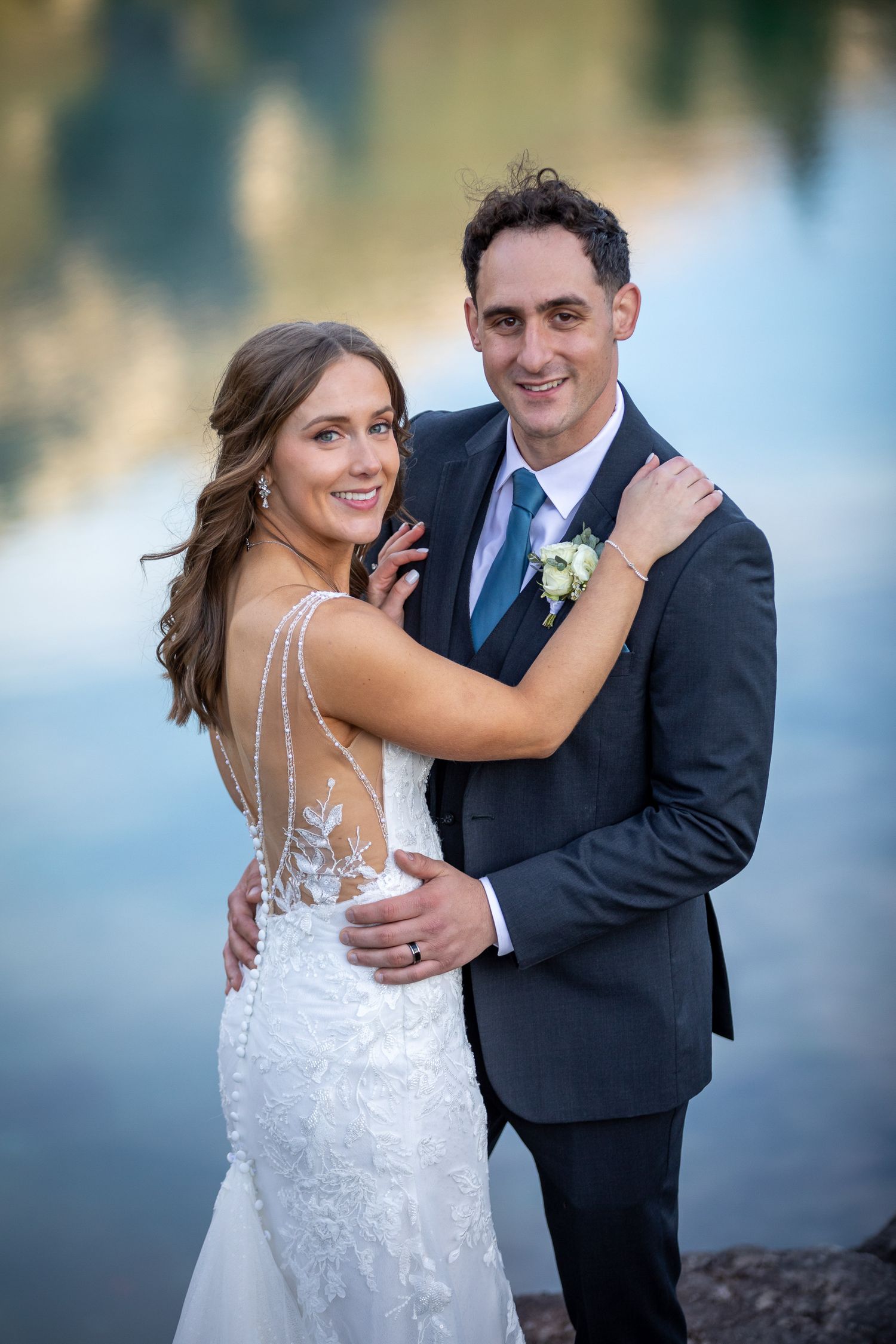 A bride and groom share romantic moments in a series of outdoor wedding photos with soft natural lighting at Silvertip resort in Canmore, AB