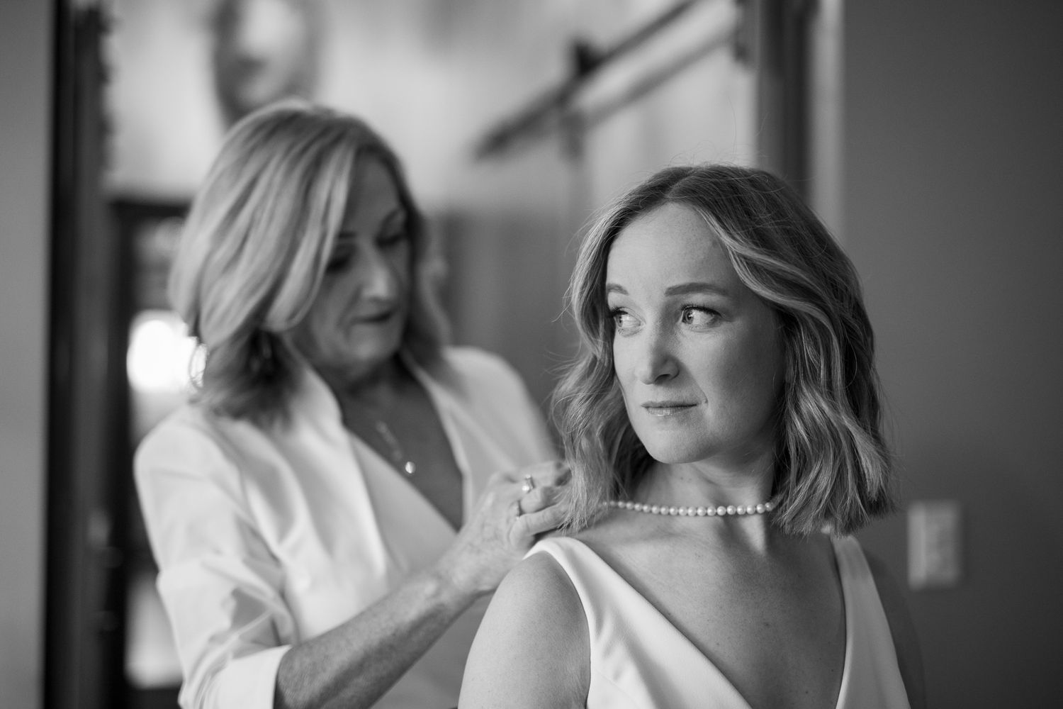 Black and white candid photos showing joyful moments during wedding preparations. Earl Grey Lodge, BC