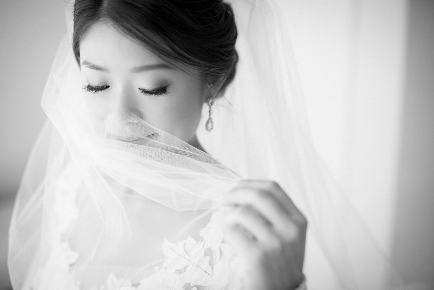 Ethereal black and white bridal portrait series showing close-up details of veil and romantic poses. Fairmont Banff springs hotel. Banff