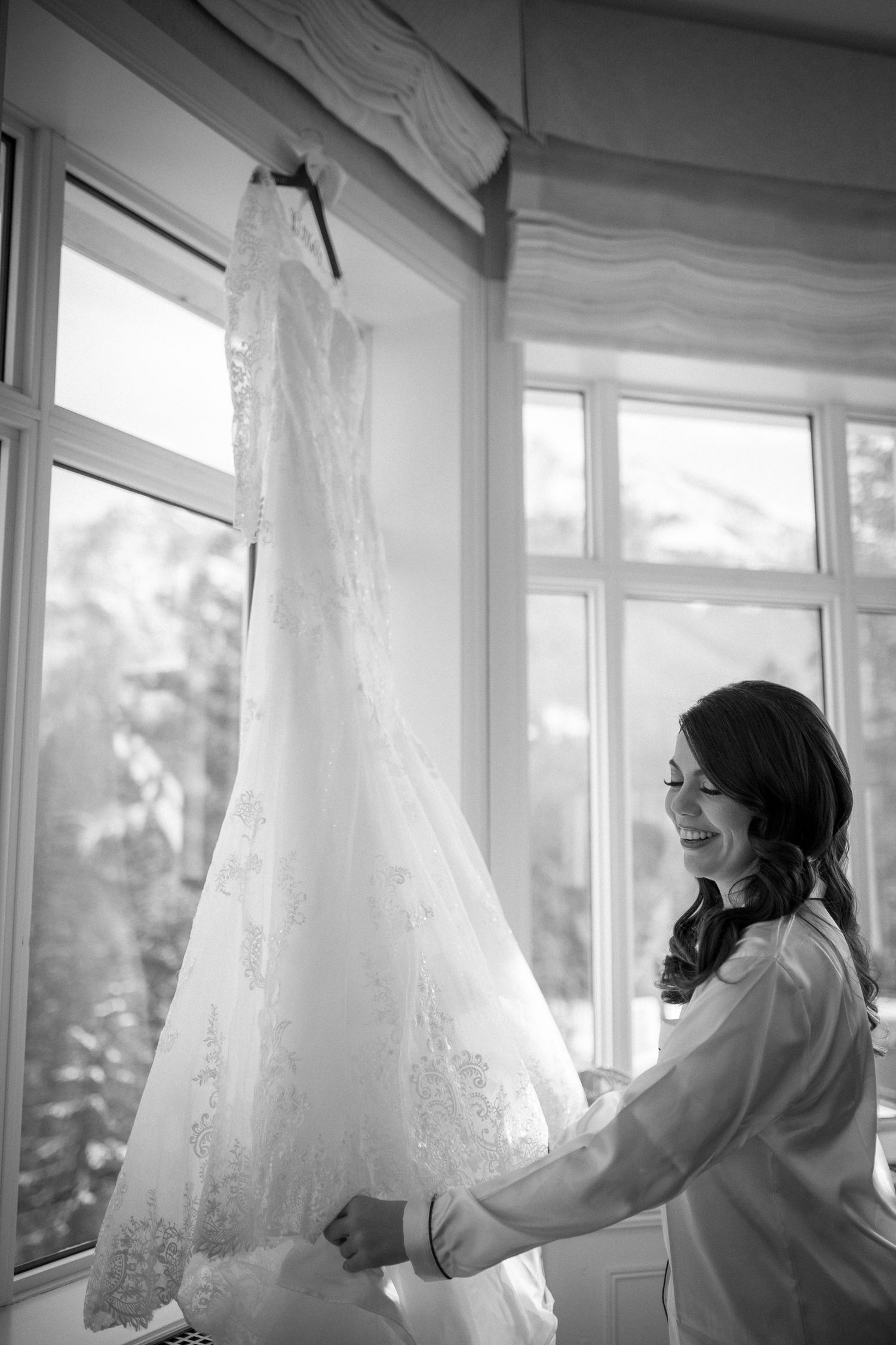 A black and white panoramic sequence shows someone adjusting sheer white curtains by sunlit windows. Fairmont Banff Springs Hotel