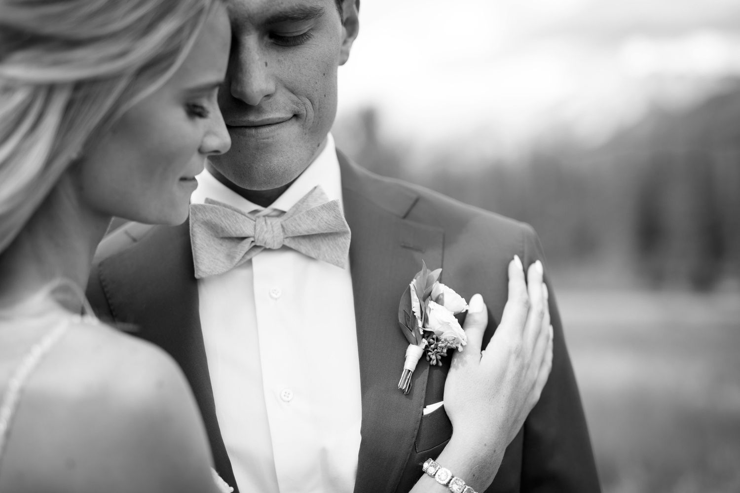 A black and white collage of romantic wedding moments showing couples embracing and sharing intimate moments together. Silvertip Canmore, AB