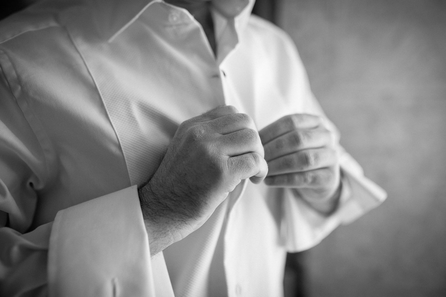 Black and white photo series showing close-up details of a martial arts practitioner's white uniform and movements.