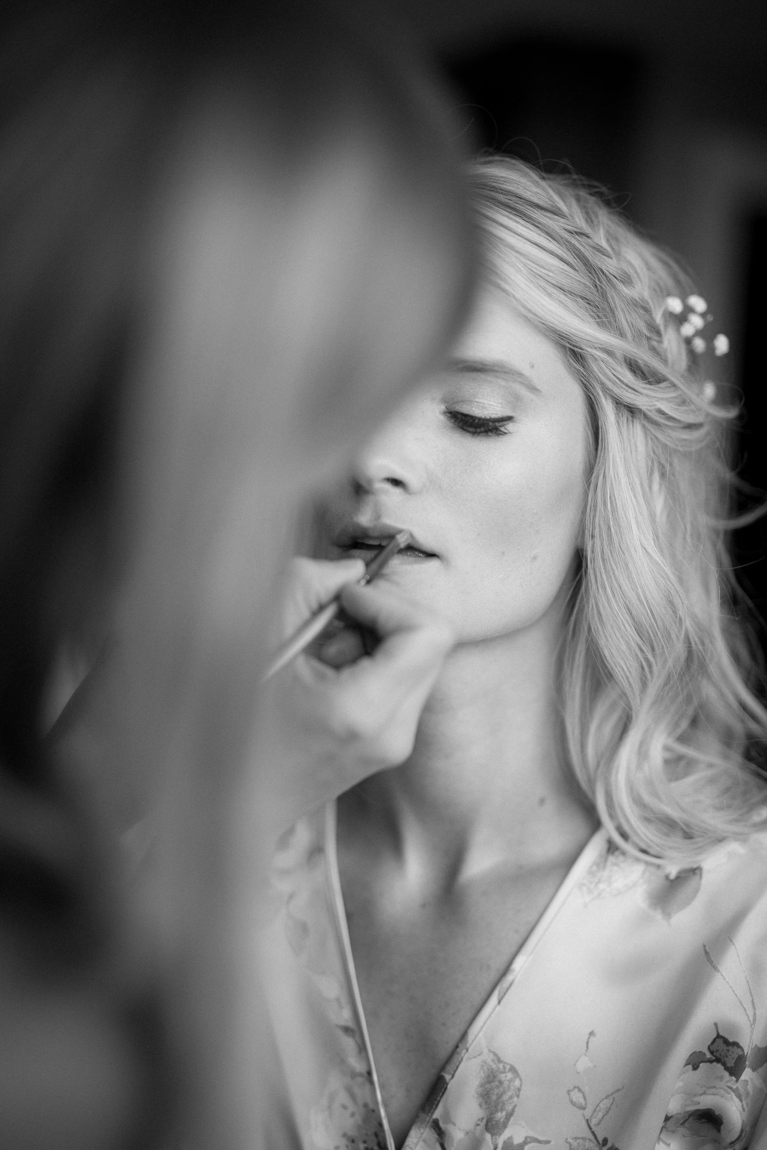 Artistic black and white portrait showing a profile view with soft lighting and ethereal mood.