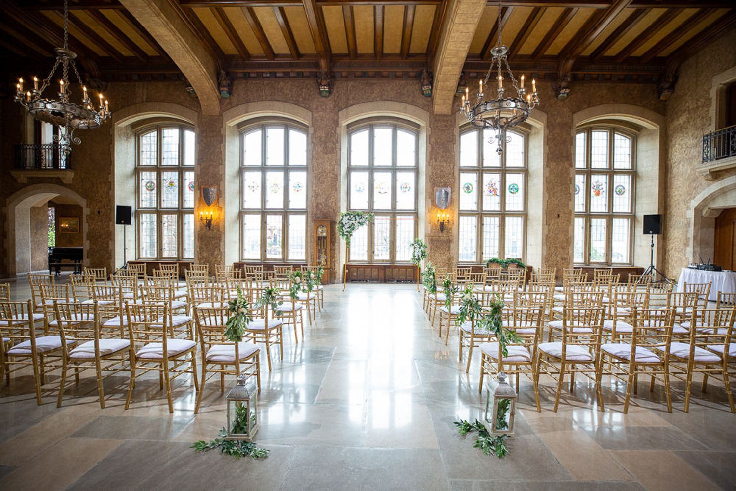 Elegant Mount Stephen Hall ballroom with rows of white chairs set up for a wedding ceremony at Fairmont Banff Springs Hotel in Banff.