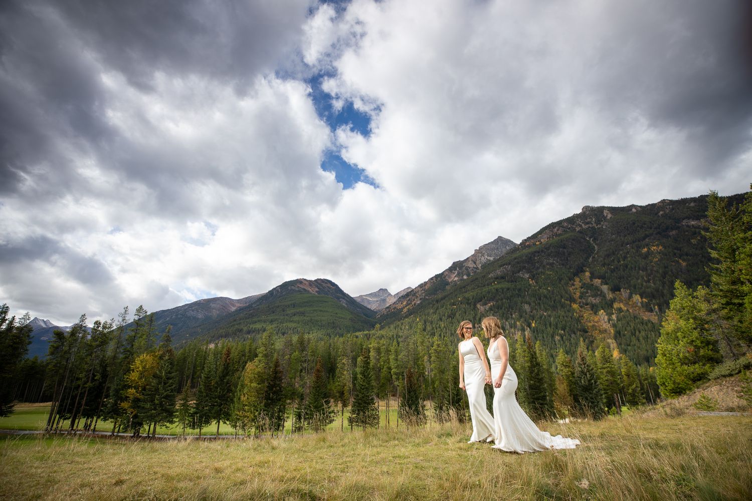A dramatic mountain landscape panorama with stormy clouds and evergreen trees in the foreground Panorama Mountain Resort.