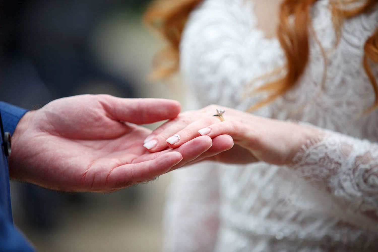 A close-up sequence of hands gently touching white delicate lace fabric material. Canmore Alberta.
