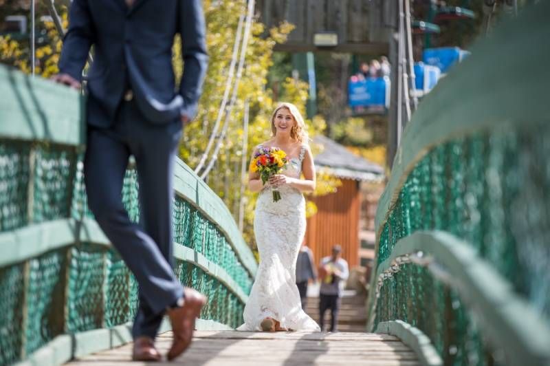 A Bride walking on a bridge at Panorama resort for a first look with groom. Invermere, BC