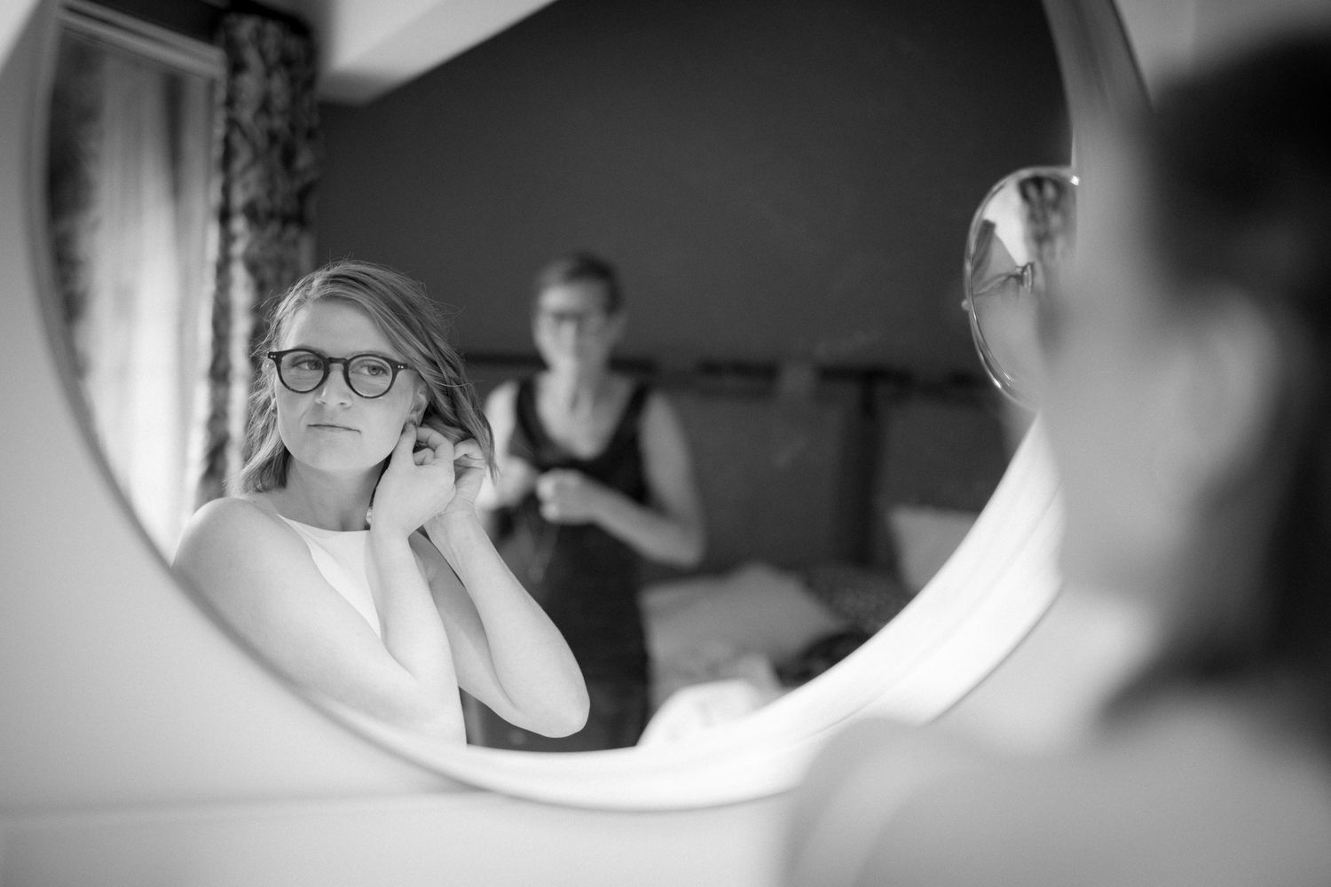 Black and white photo series showing reflections in round mirrors creating an artistic composition. Earl Grey Lodge, BC