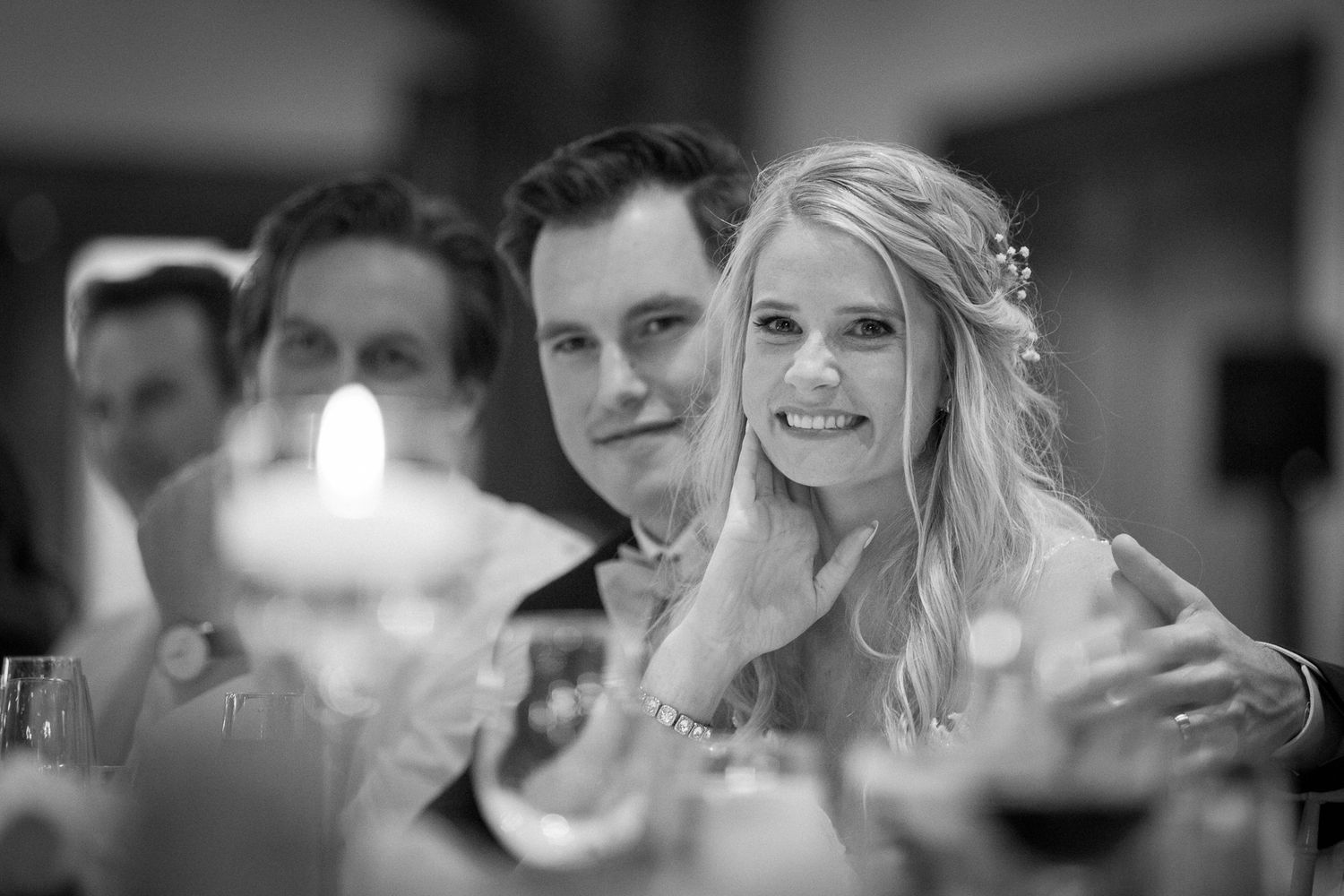 A joyful wedding reception moment with people celebrating and dancing together in a dimly lit venue. Silvertip resort in Canmore.
