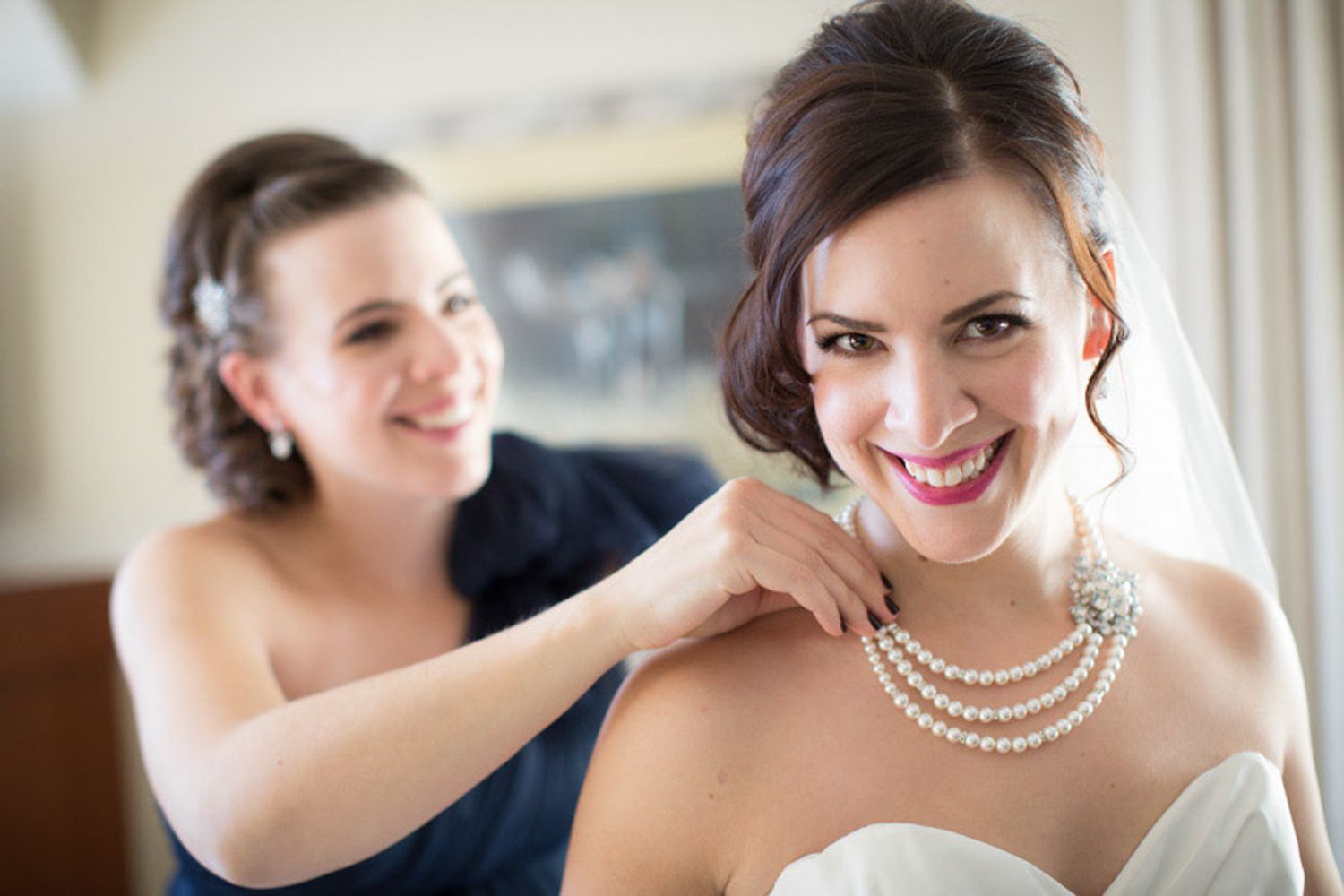 A series of bridal preparation photos showing pearl necklaces, makeup application and joyful moments before the wedding. Canmore, AB