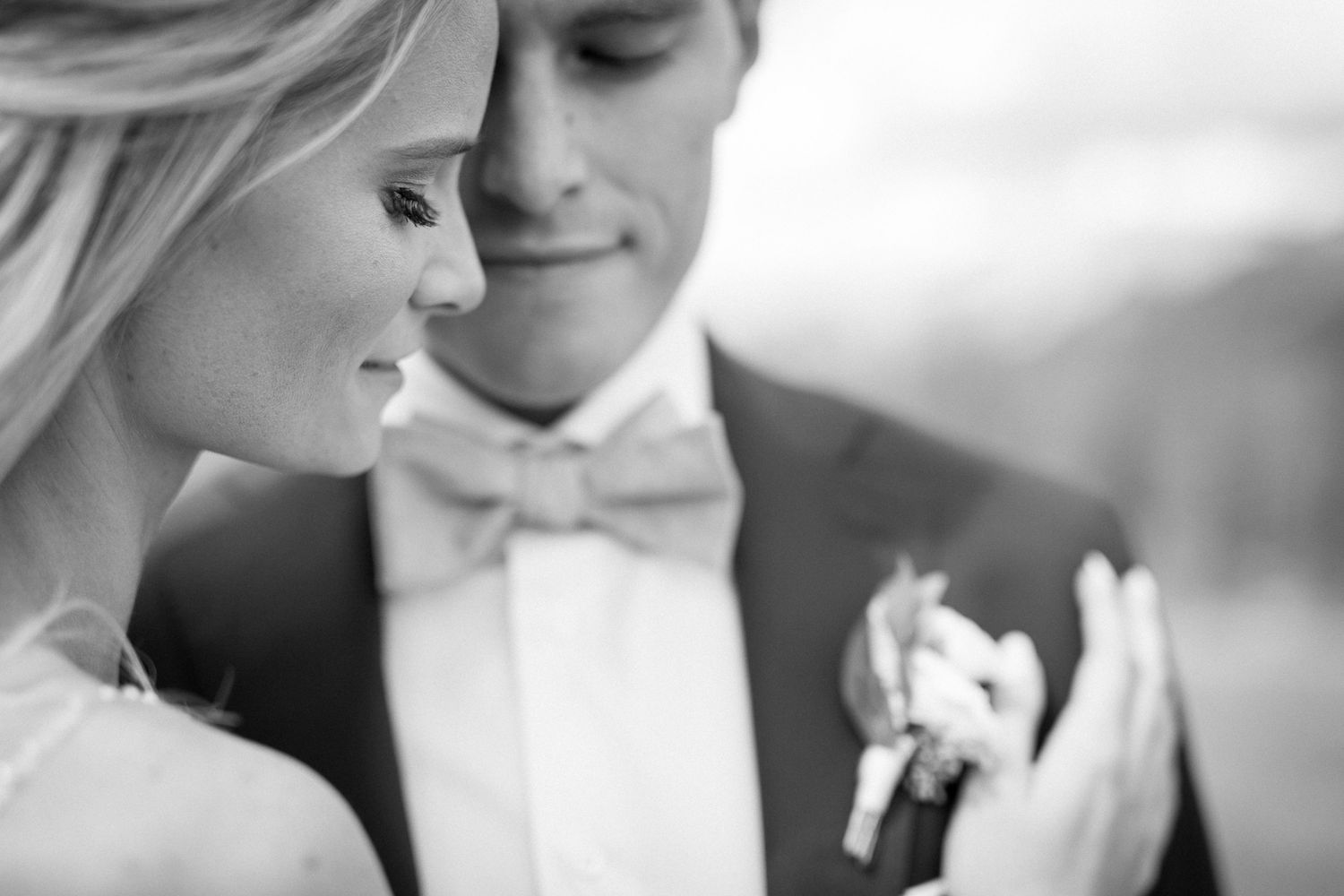 Black and white photo of a romantic wedding couple sharing intimate moments in a series of close-up shots. Silvertip Canmore, AB
