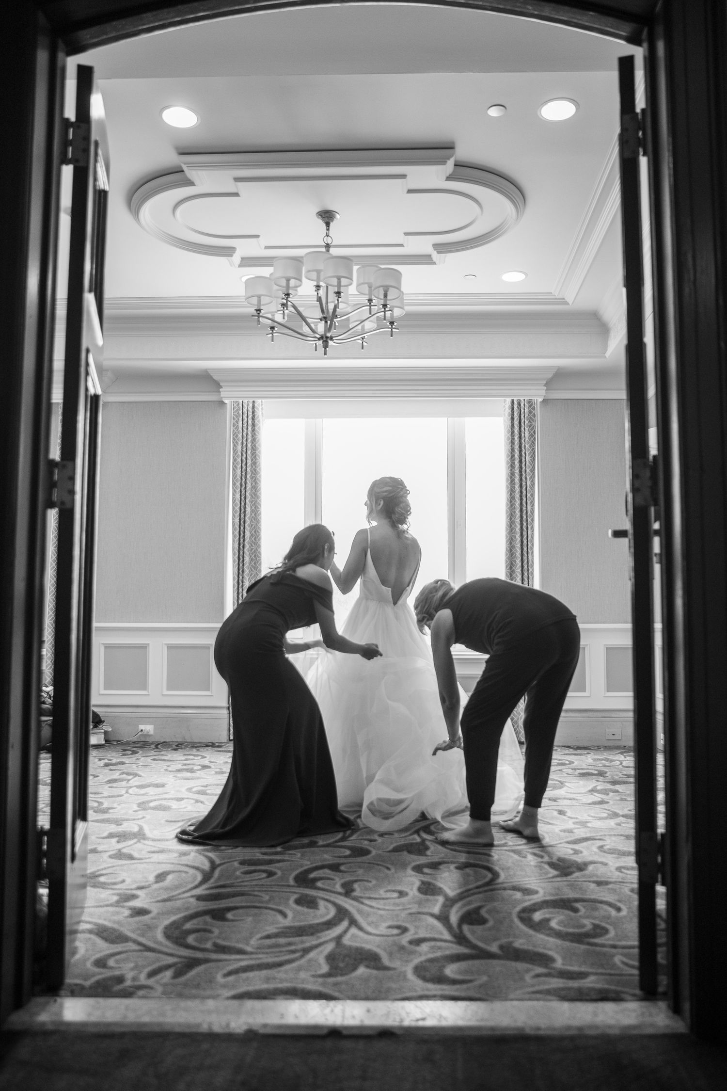 A sequence of black and white wedding preparation photos showing a person in a dress getting ready in an elegant hallway.
Lake Louise, AB