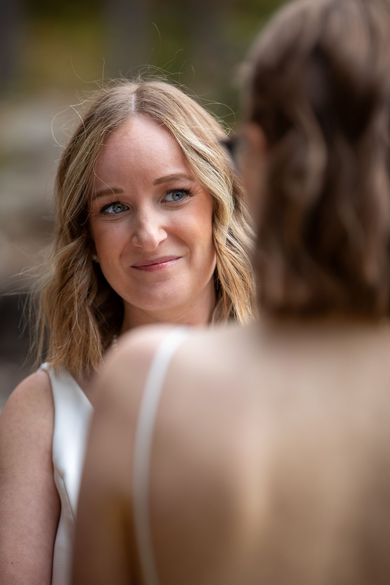 A series of five cropped portraits showing changing facial expressions with soft bokeh background effect.