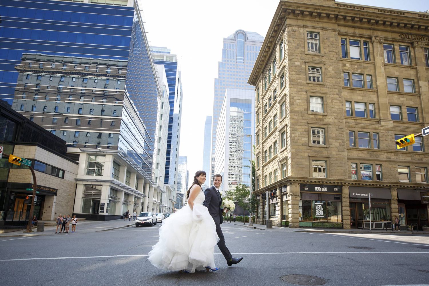 Wedding photography sequence showing couple walking through urban Calgary city streets. Calgary Alberta.