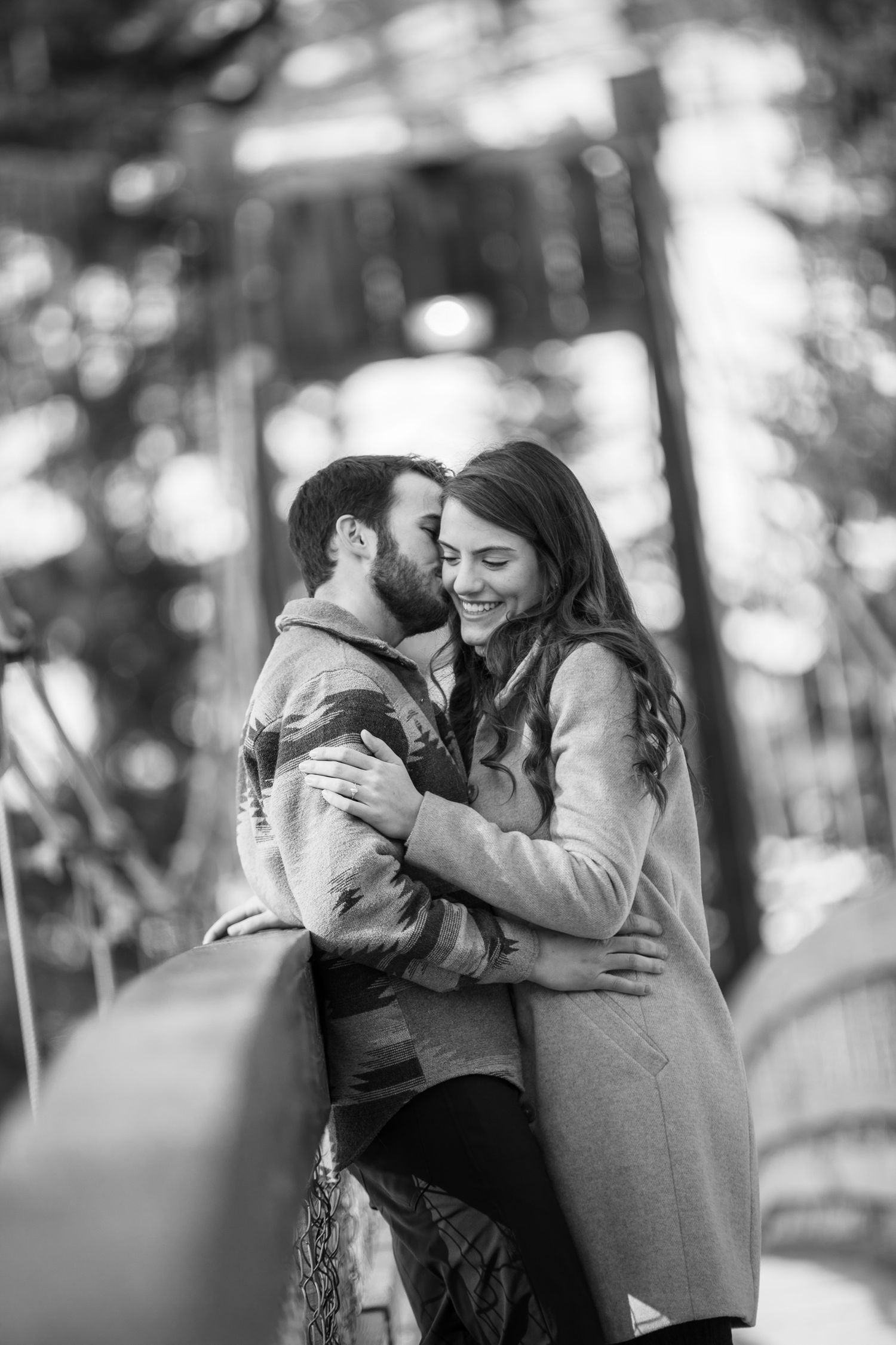 A romantic black and white photo sequence showing a couple embracing and sharing intimate moments in a forest setting at Grey Wolf Panorama,
