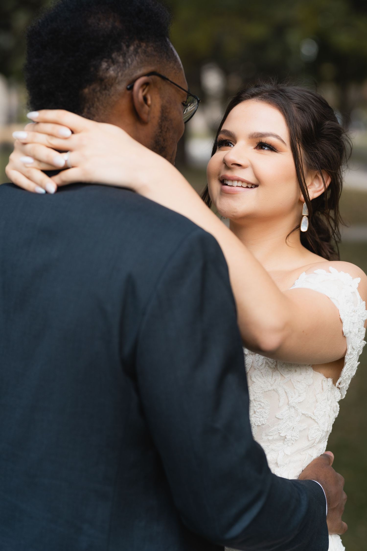 Close-up shot of a couple embracing during their wedding celebration.