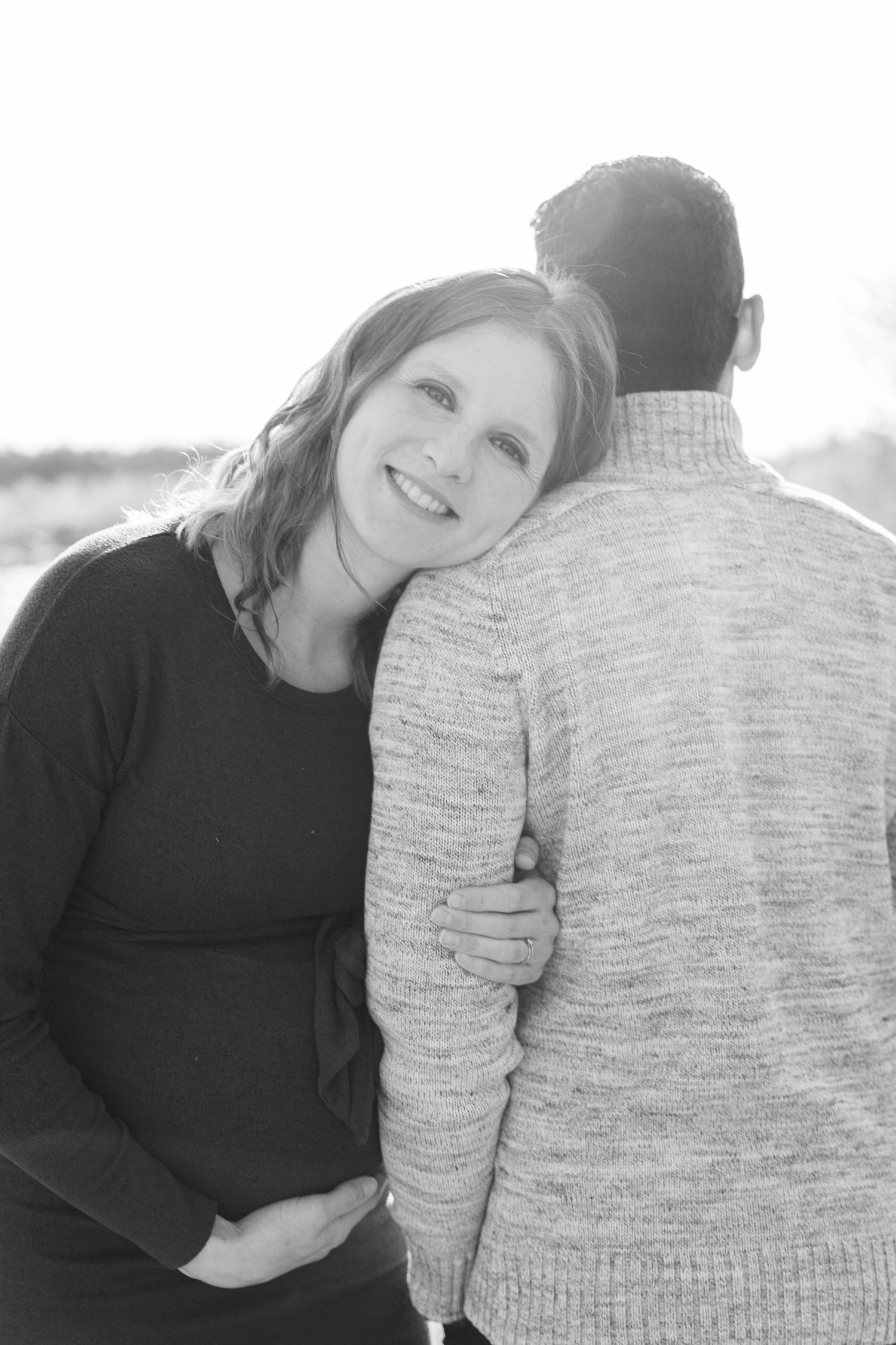 Intimate maternity photo of expectant couple in black and white.