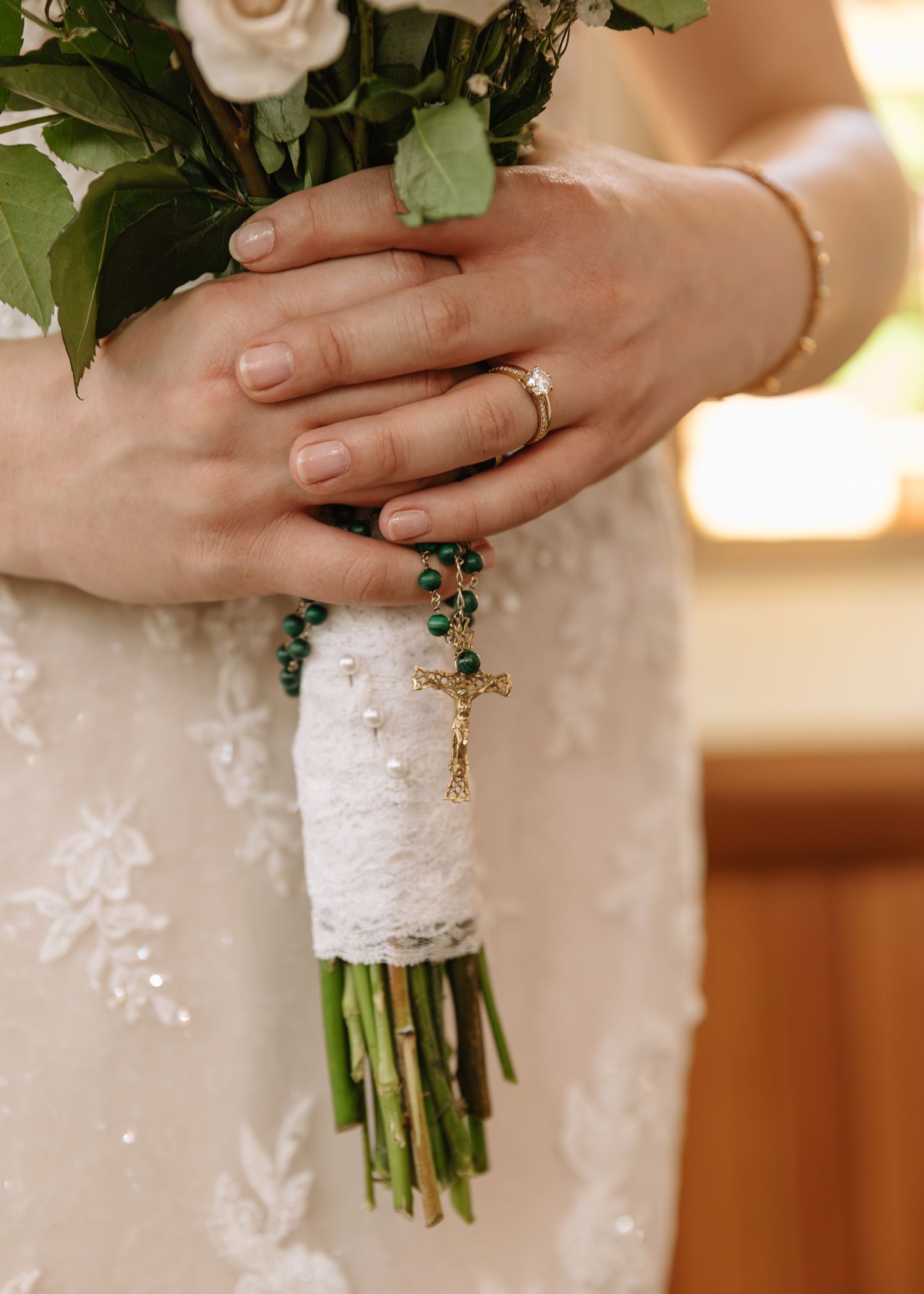 A close-up series of hands holding a white rose wedding bouquet wrapped in lace, showcasing an engagement ring.