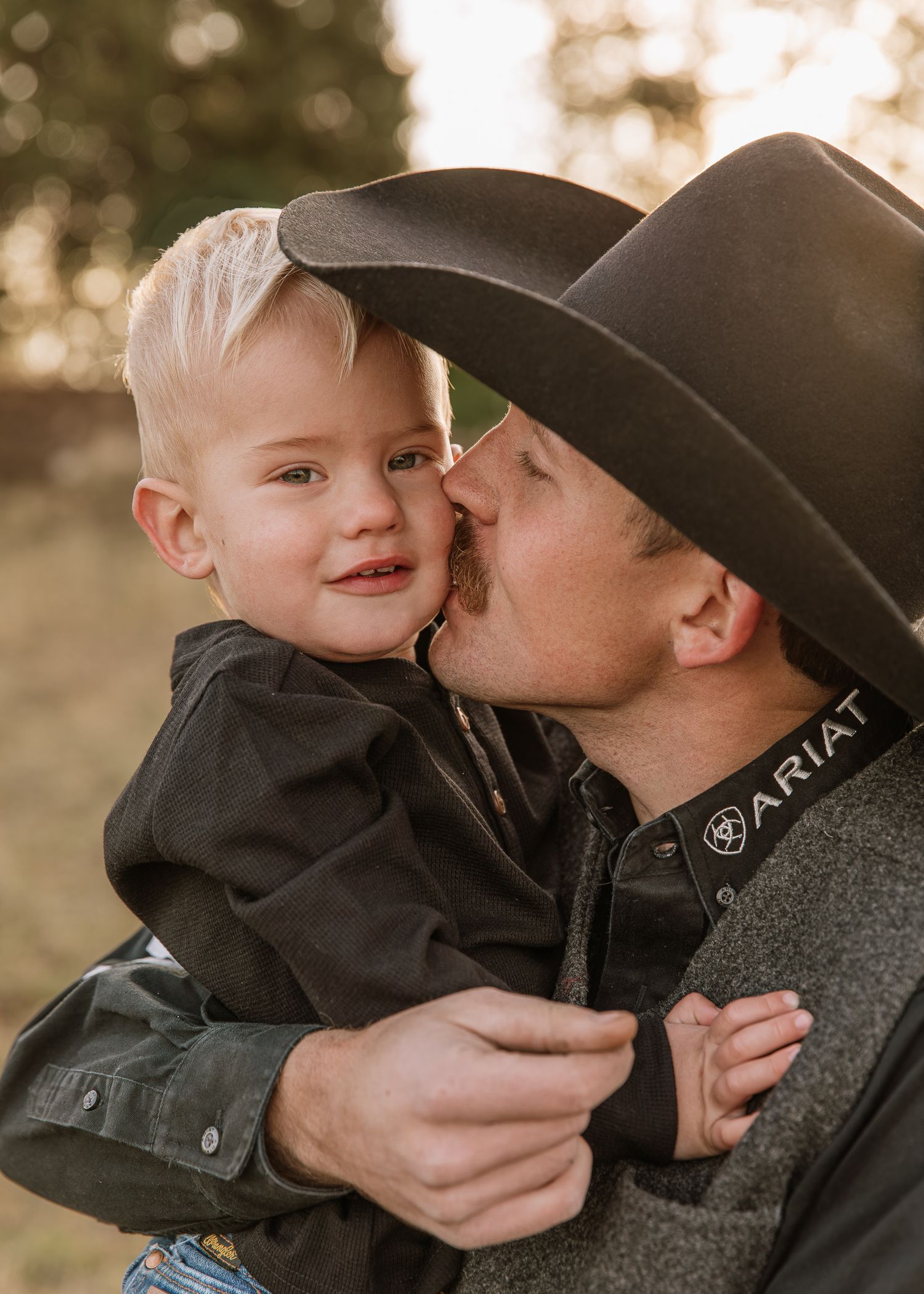 A tender moment between parent and child captured in a series of warm, outdoor portraits at sunset.