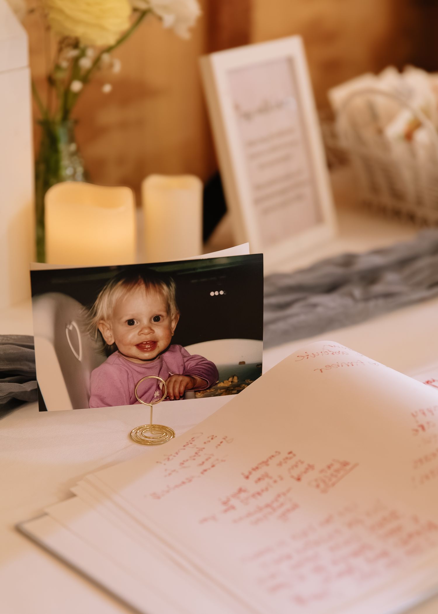 A handwritten guest book or journal page with text in pink ink displayed on a white surface.
