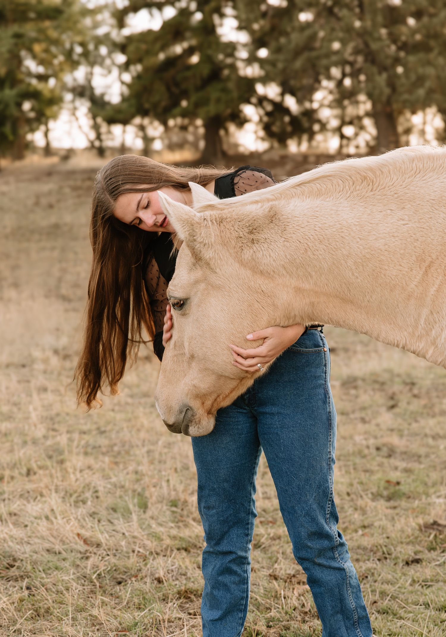 A series of photos showing a person in jeans bending over while a light-colored horse playfully nudges them from behind.