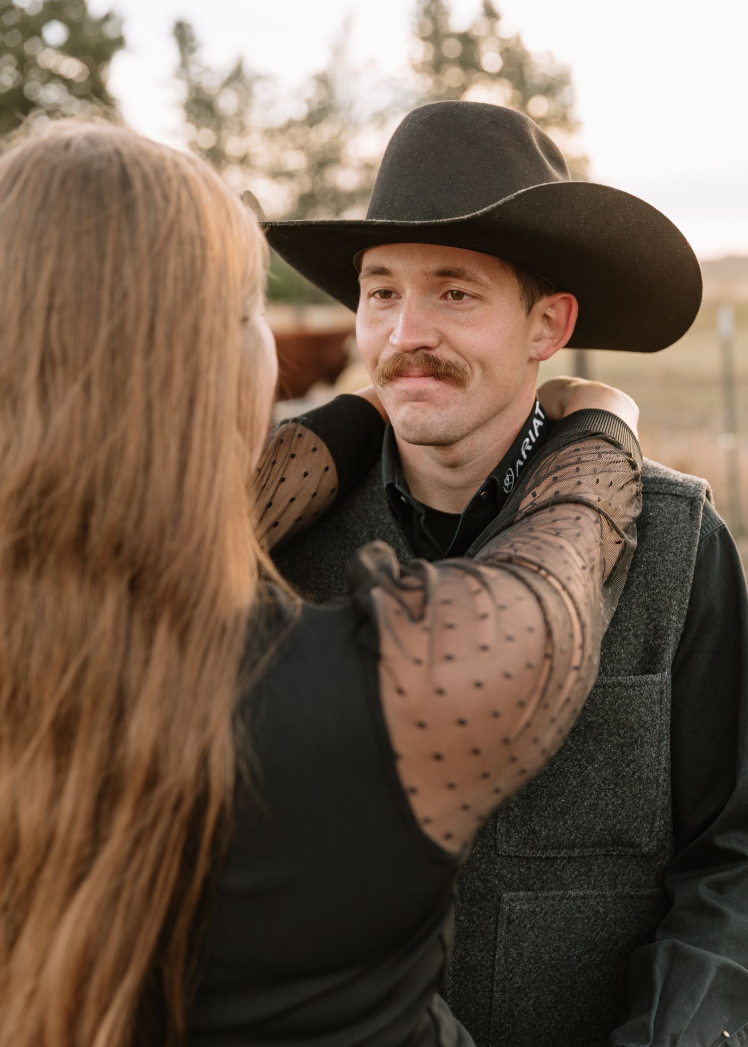 A couple embraces and shares a tender moment outdoors in a romantic photoshoot series.