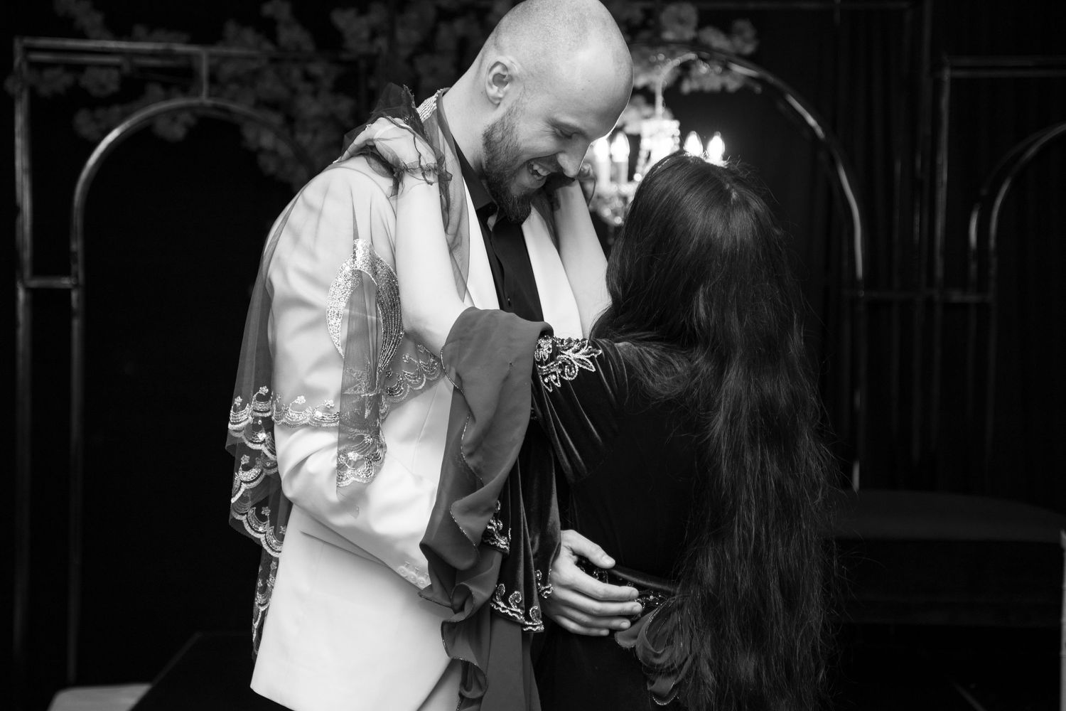 A romantic black and white series of photos showing a tender dance between a couple at night.