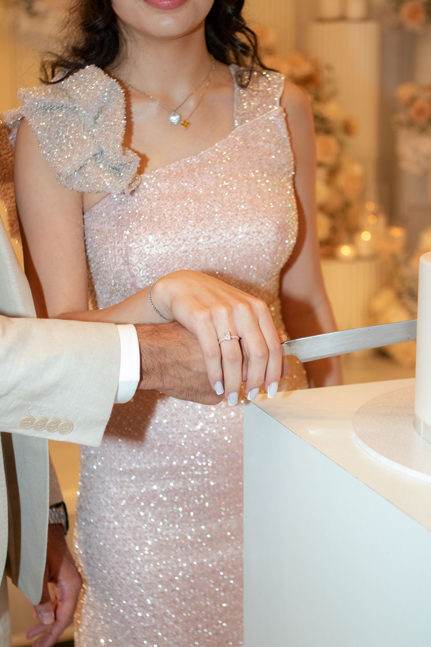 Close-up sequence of a sparkly pink dress showing intricate beaded details and shimmer.