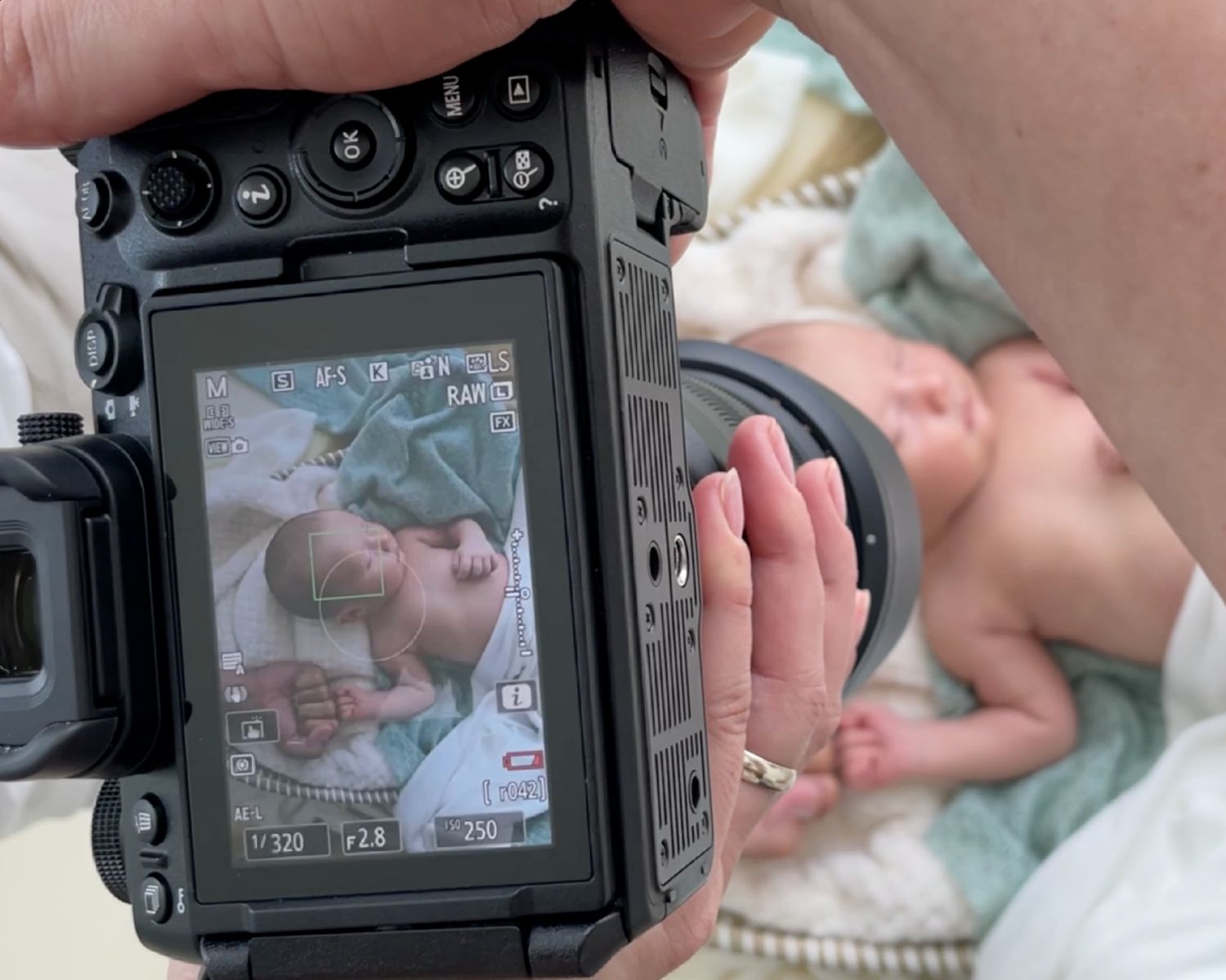 Camera viewfinder displays hands counting money against a grey background.
