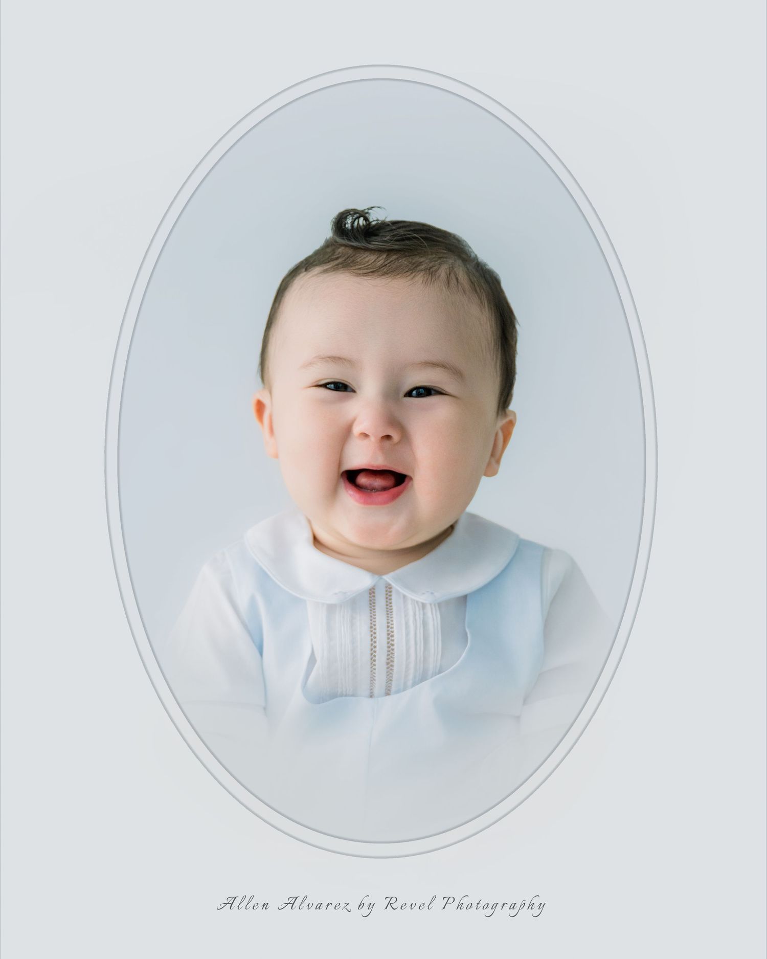 Smiling baby in white outfit posed in oval vignette portrait by Revel Photography.