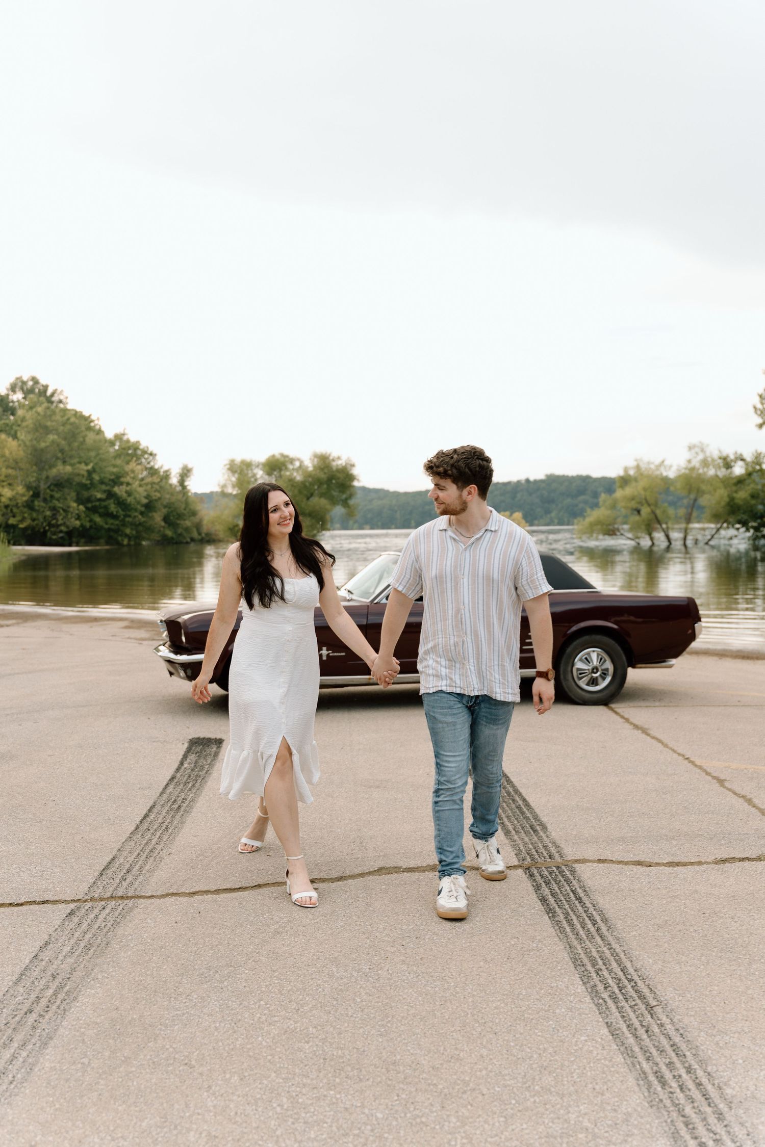 Romantic engagement photos featuring a vintage car at Lake Monroe in Bloomington, Indiana.