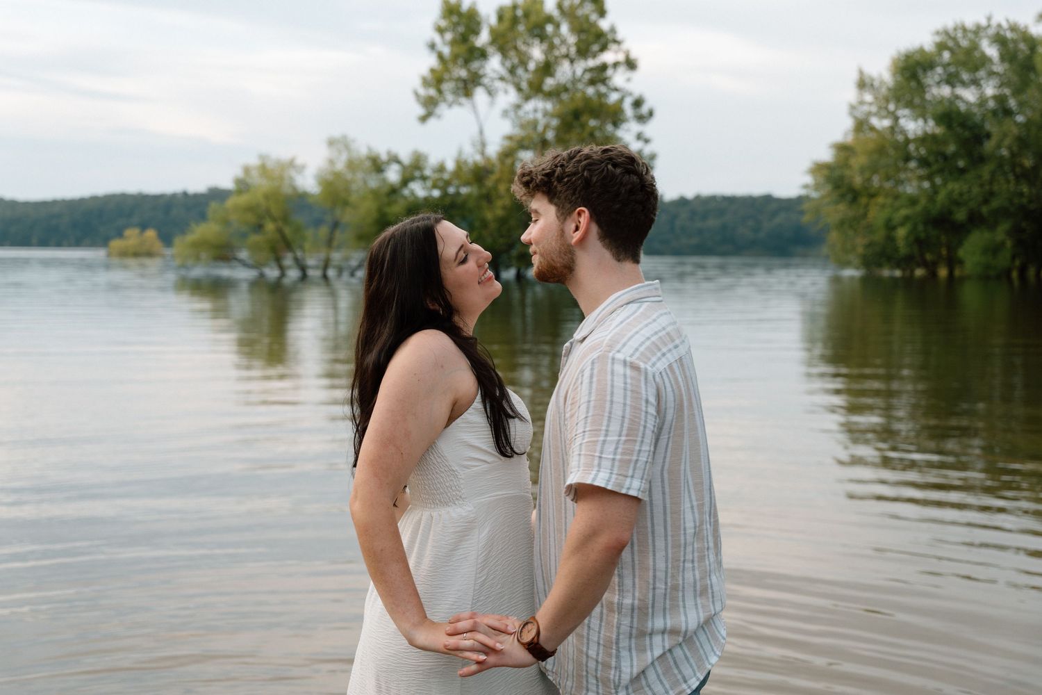Romantic engagement photos featuring a vintage car at Lake Monroe in Bloomington, Indiana.