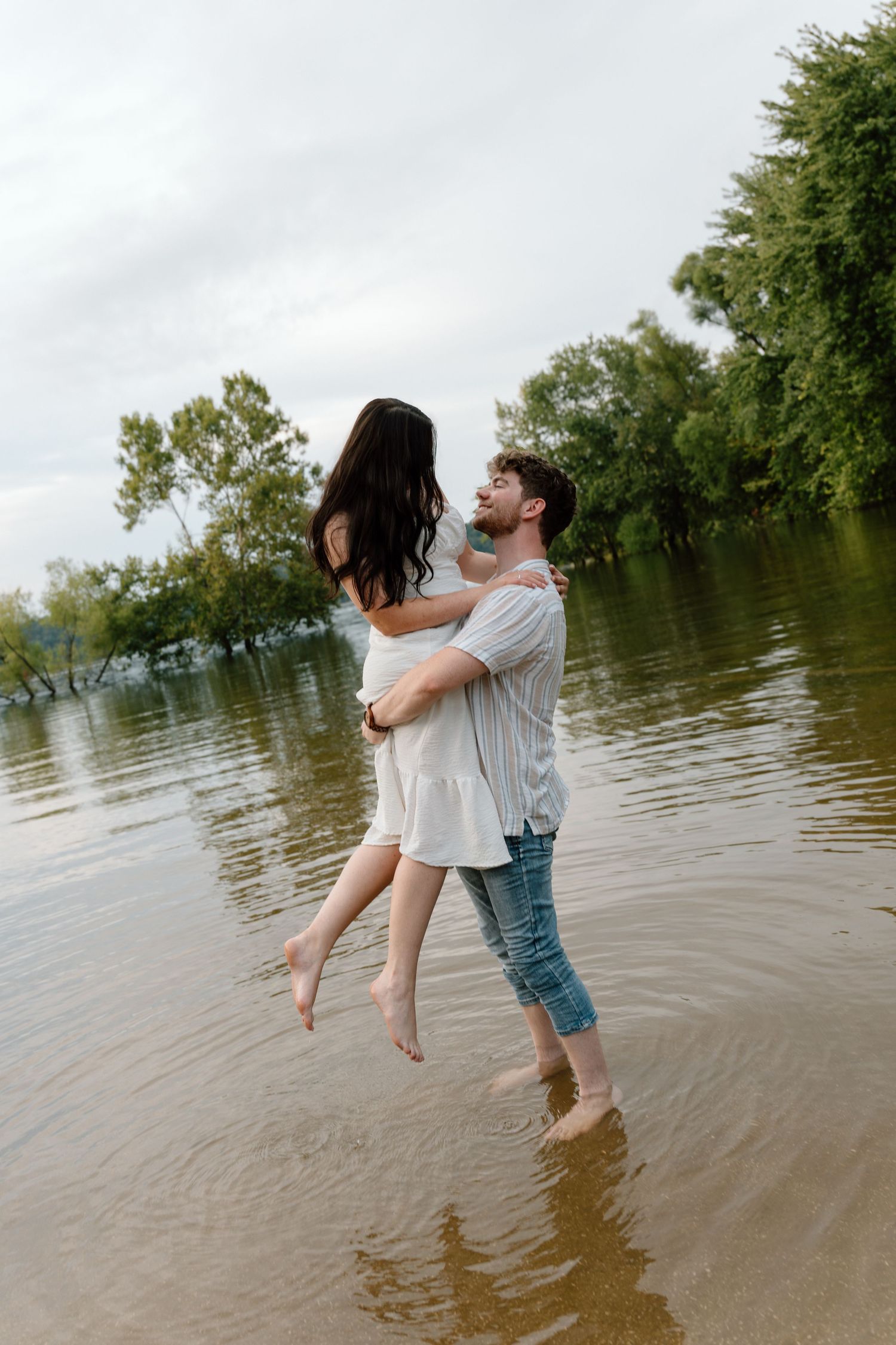 Romantic engagement photos featuring a vintage car at Lake Monroe in Bloomington, Indiana.