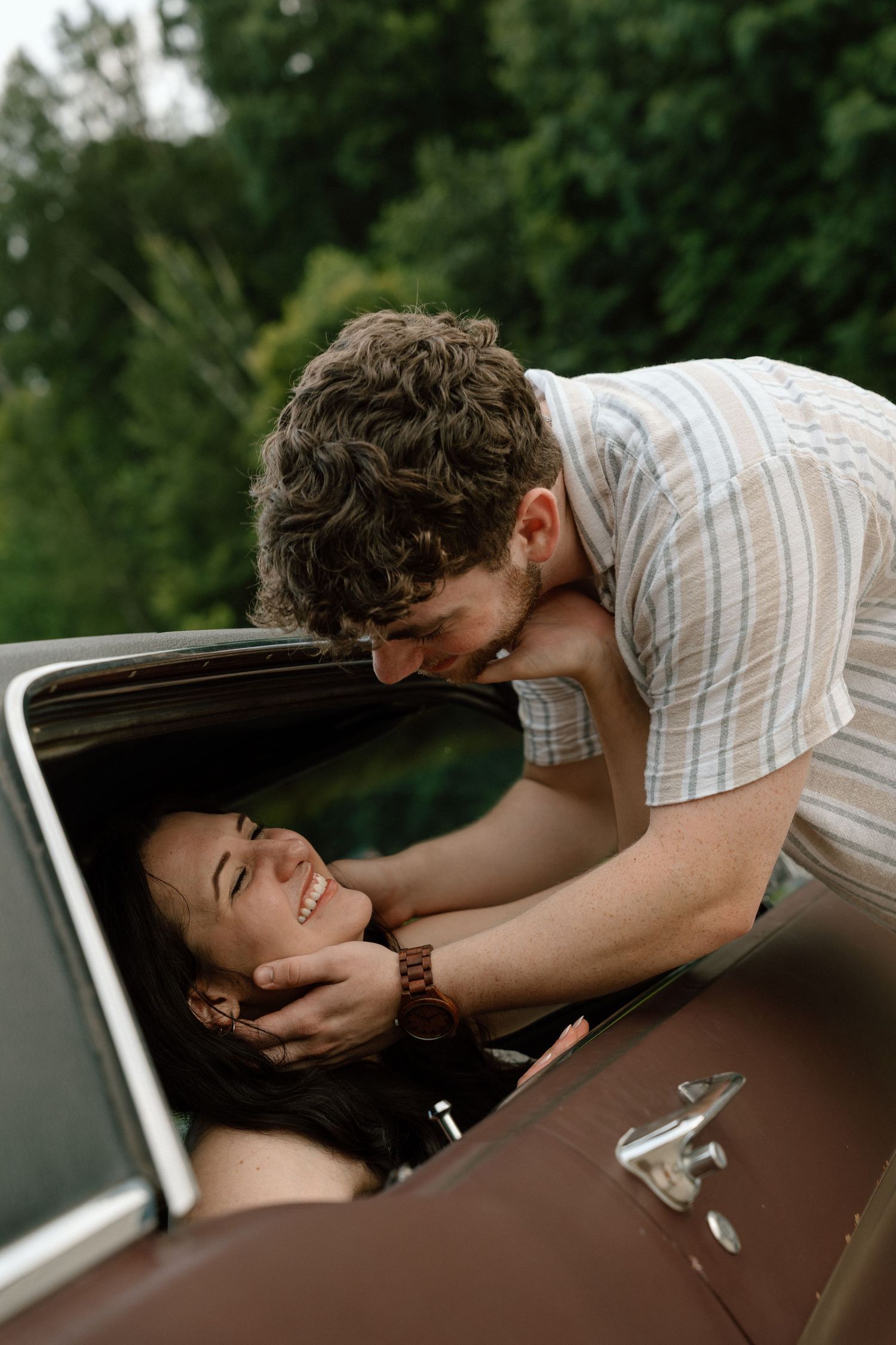 Romantic engagement photos featuring a vintage car at Lake Monroe in Bloomington, Indiana.