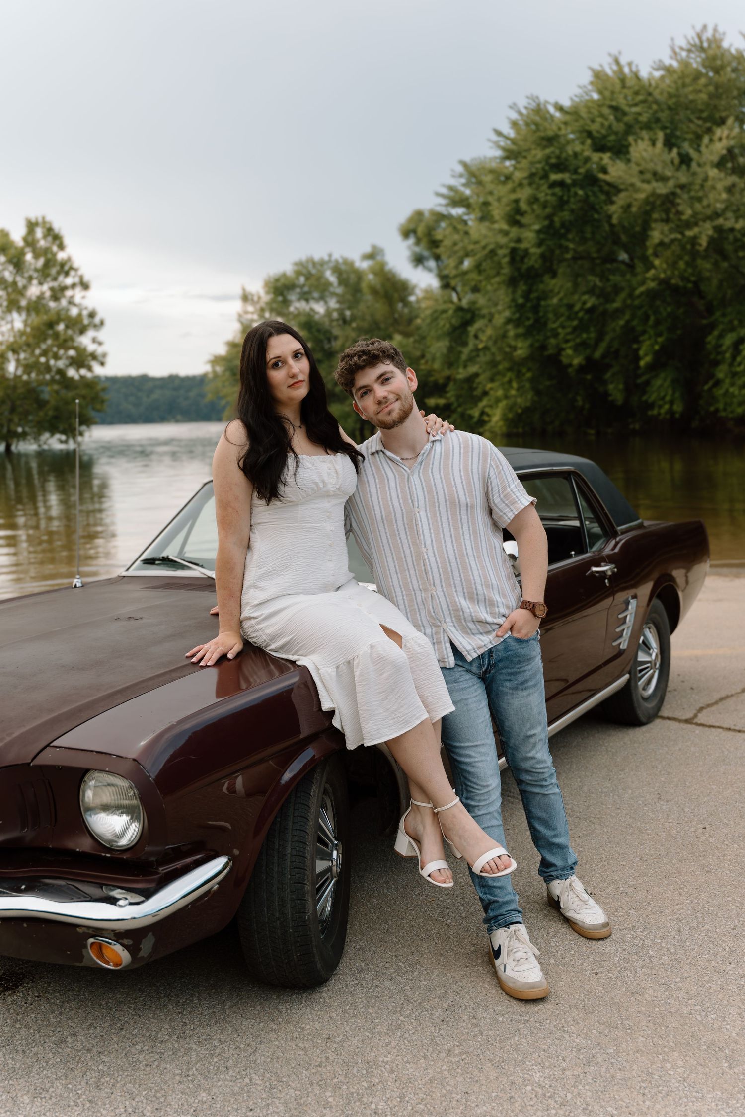Romantic engagement photos featuring a vintage car at Lake Monroe in Bloomington, Indiana.