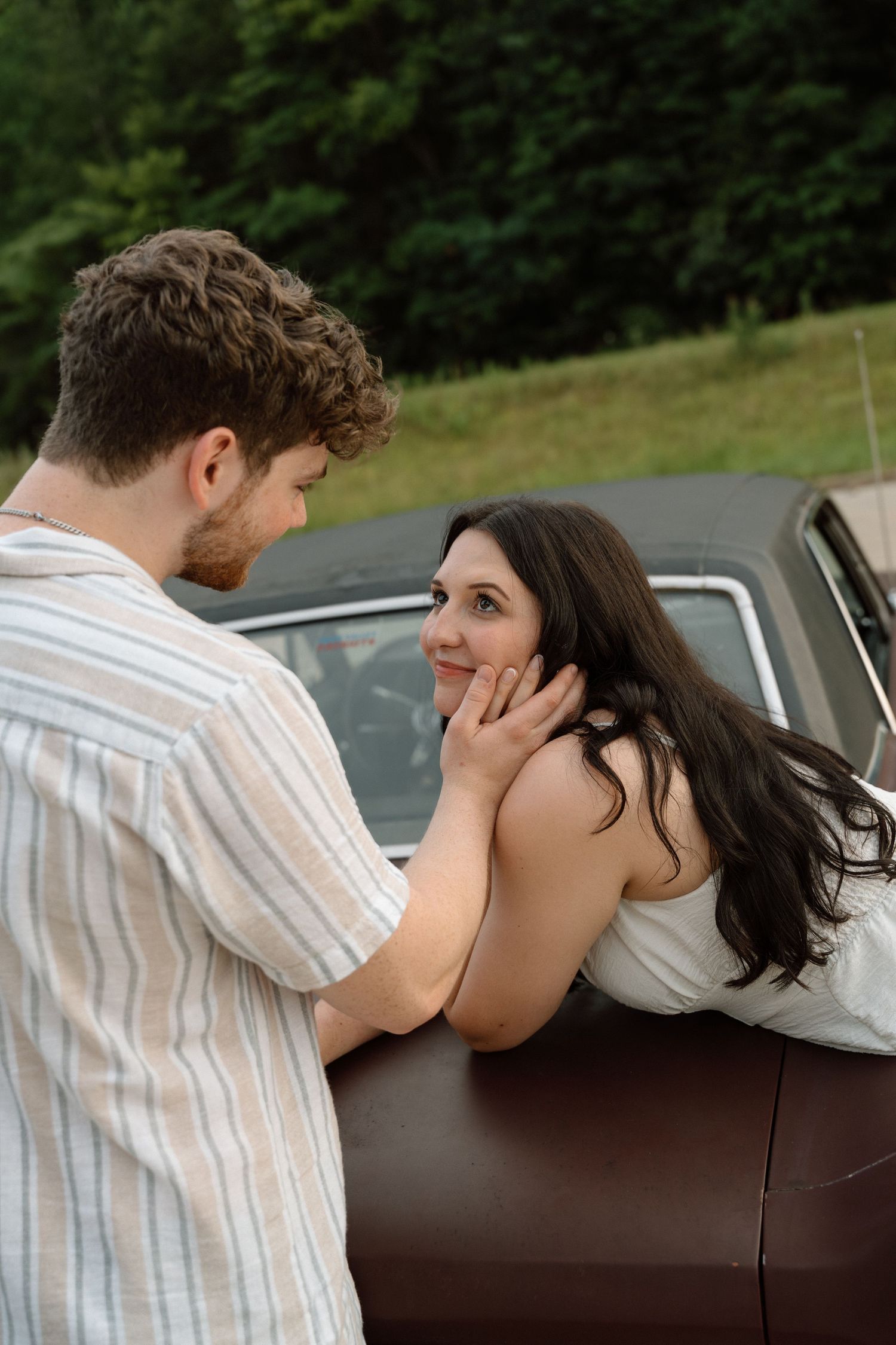 Romantic engagement photos featuring a vintage car at Lake Monroe in Bloomington, Indiana.