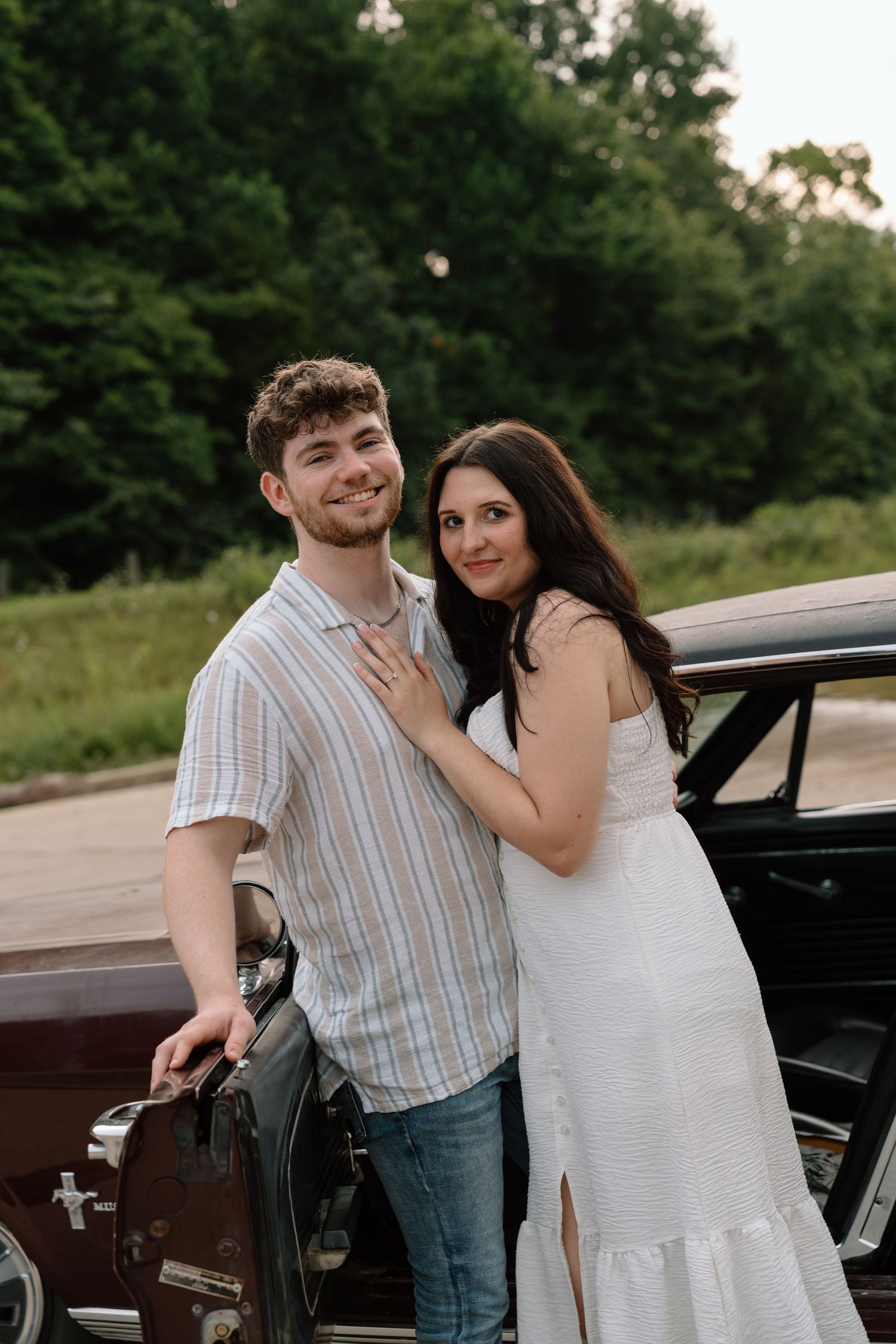 Romantic engagement photos featuring a vintage car at Lake Monroe in Bloomington, Indiana.