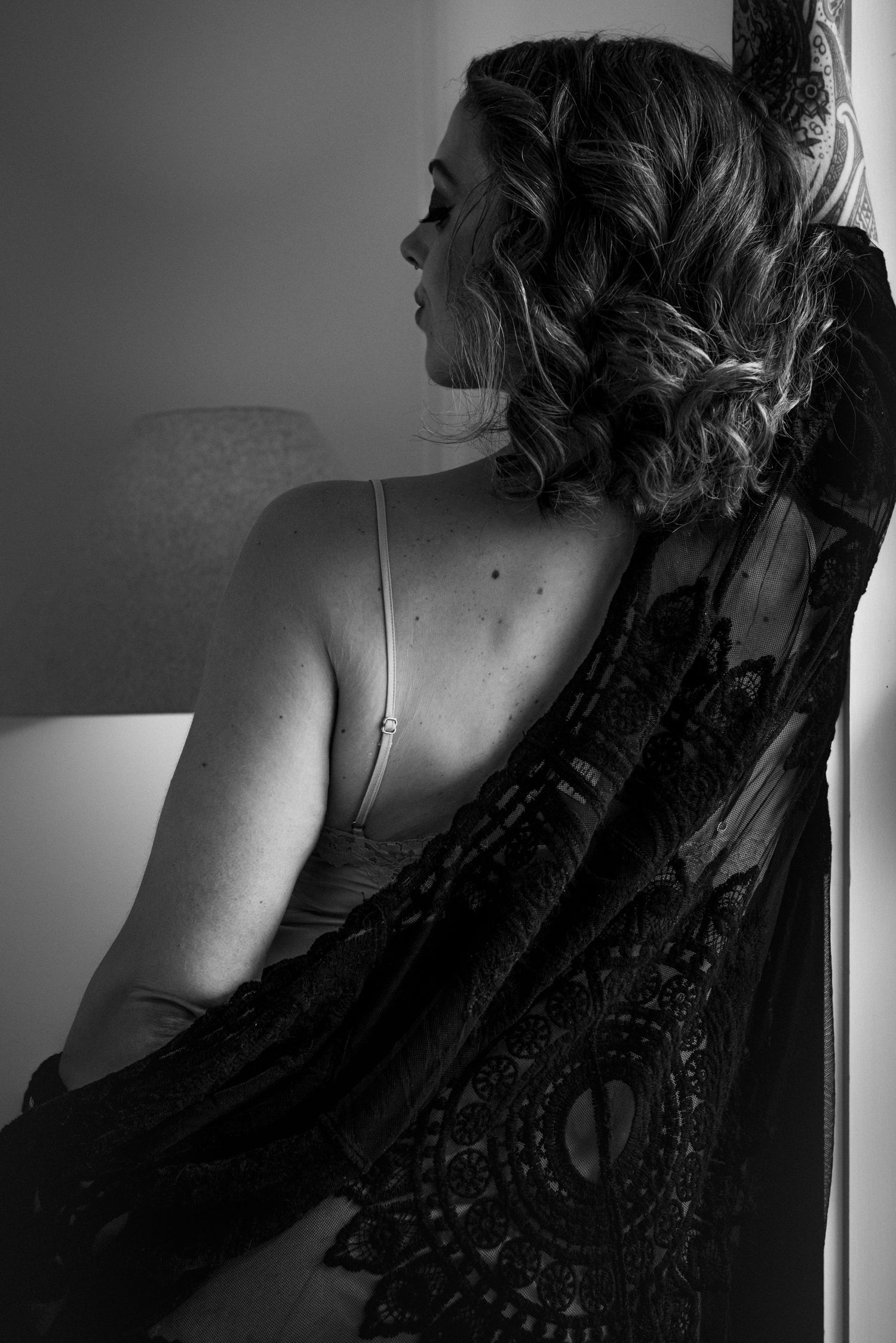 Artistic black and white portrait series showing intimate angles and shadows in low light.