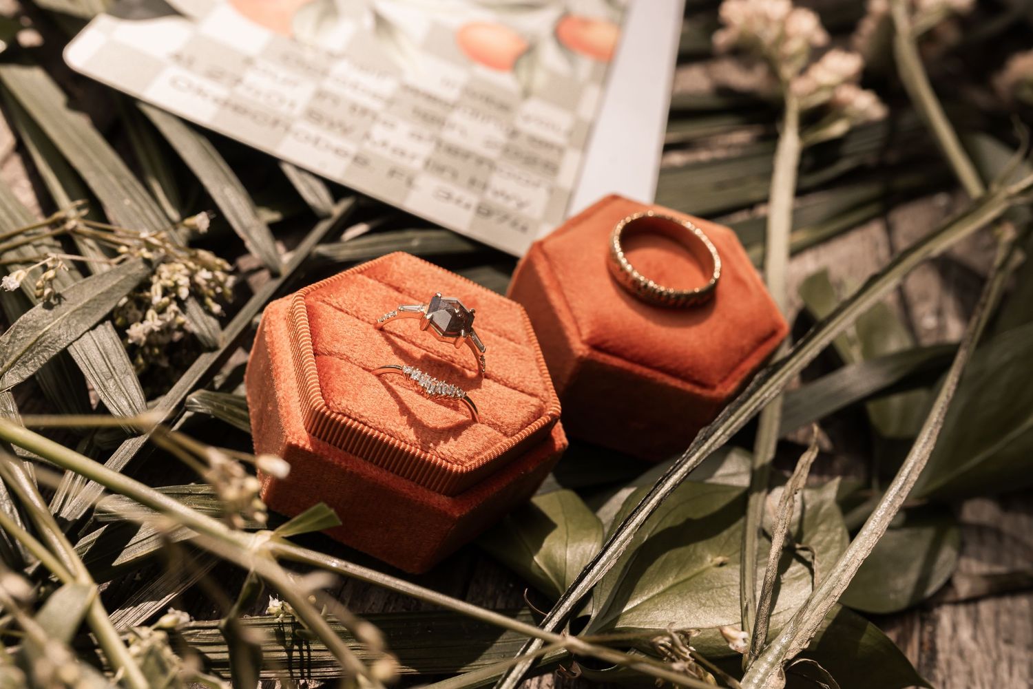 A rustic collection of vintage red clay bricks scattered among dried grass and leaves.